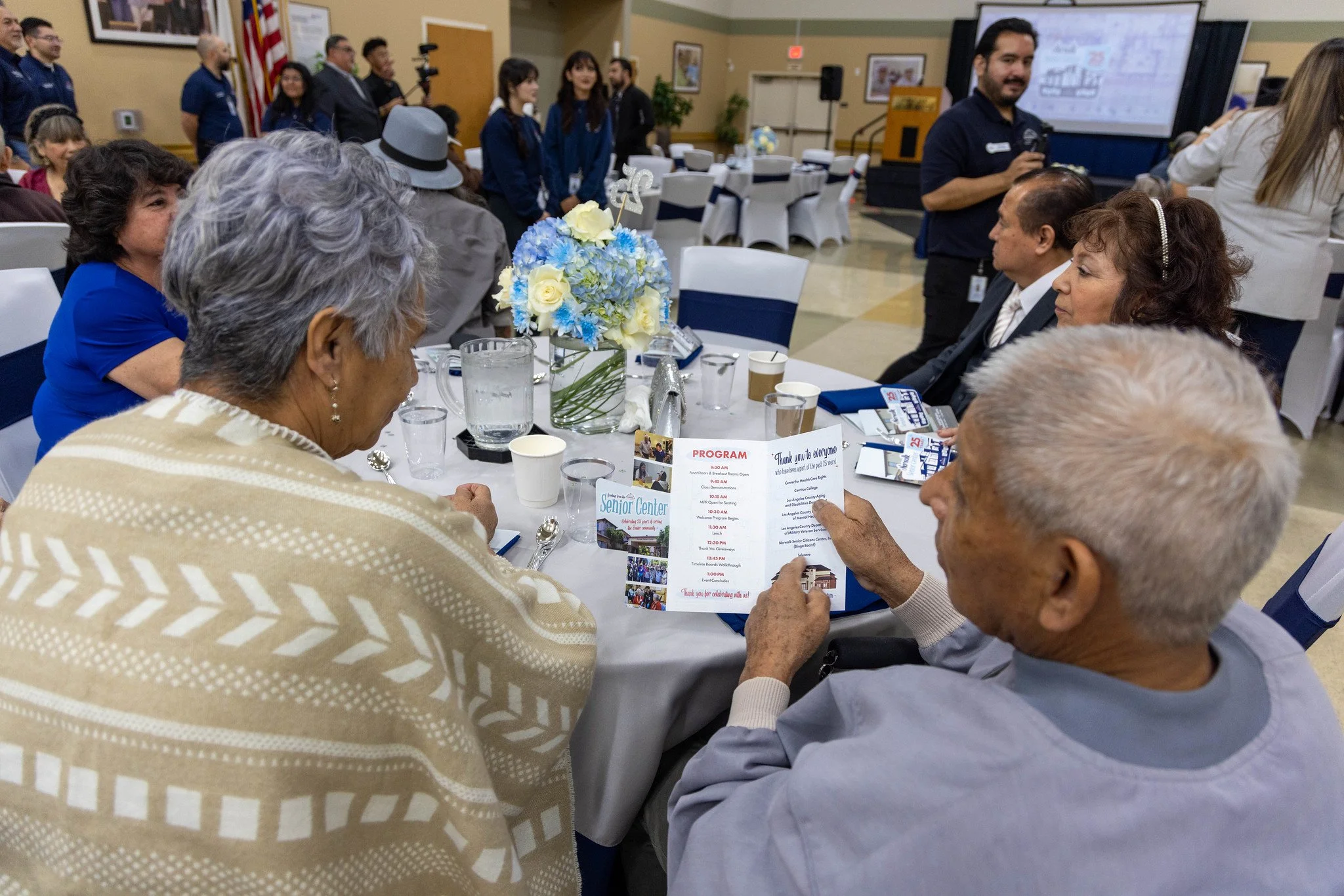 Seniors reading the program