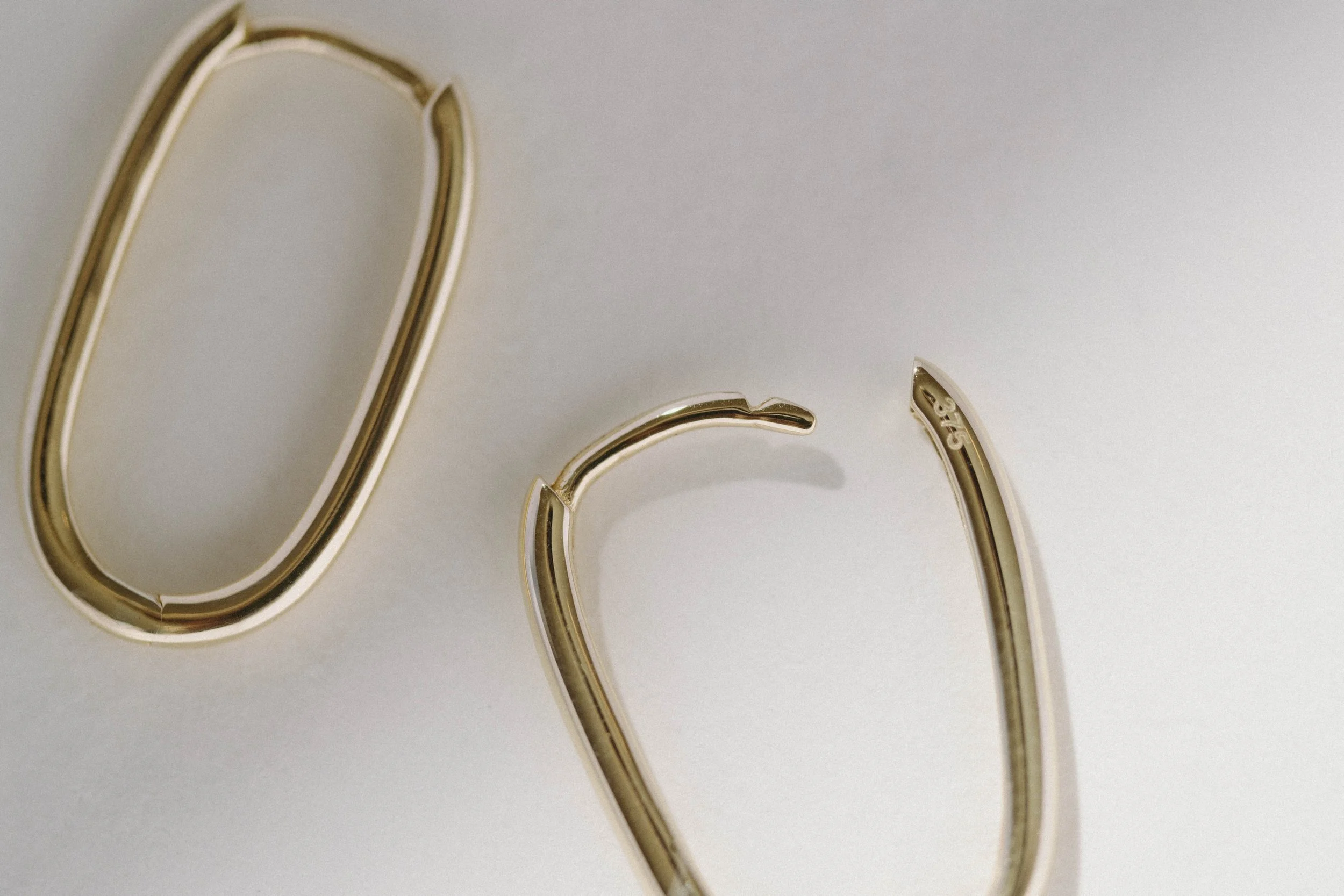 Oval_huggies_yellow_gold-MINERAL RENAISSANCE-SOLID-GOLD-_MC25570.jpg