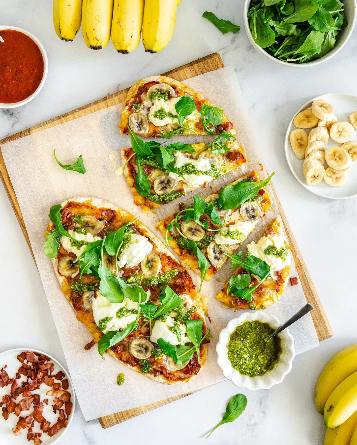 Recipe: Bacon, Banana and Burrata Flatbread Pizzas // This isn’t your everyday flatbread pizza. We’re pairing crispy savoury bacon with the sweet, creamy comfort of ripe bananas and topping it with gooey burrata cheese and basil pesto. Ea