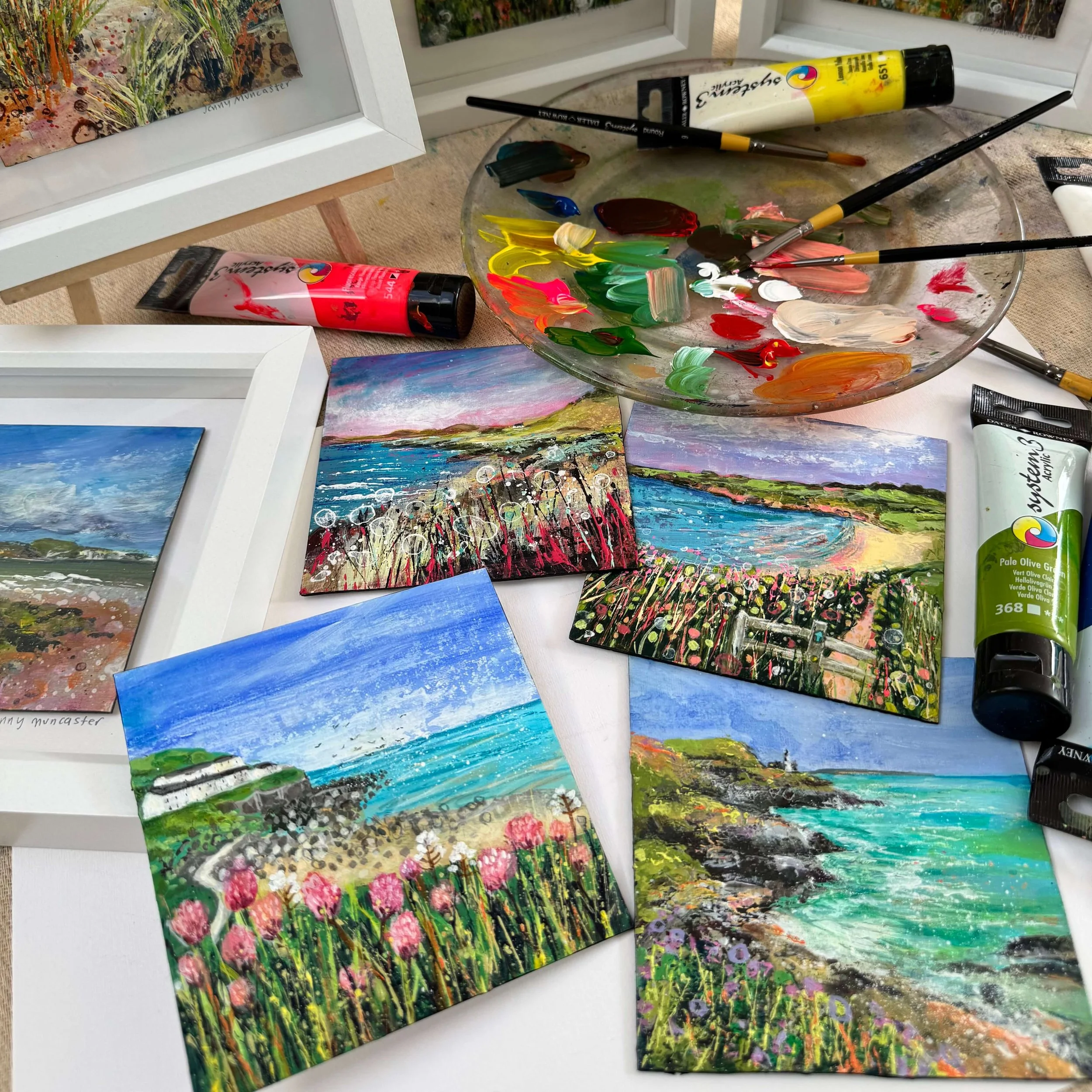 Small versions of a big painting , with paintbrushes and paint