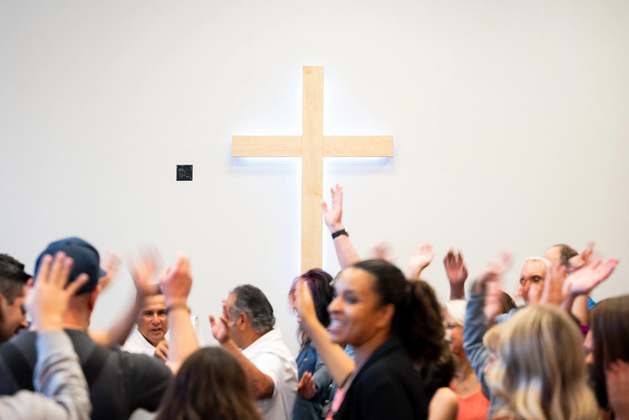 people=-hands-up-behind-cross.jpg