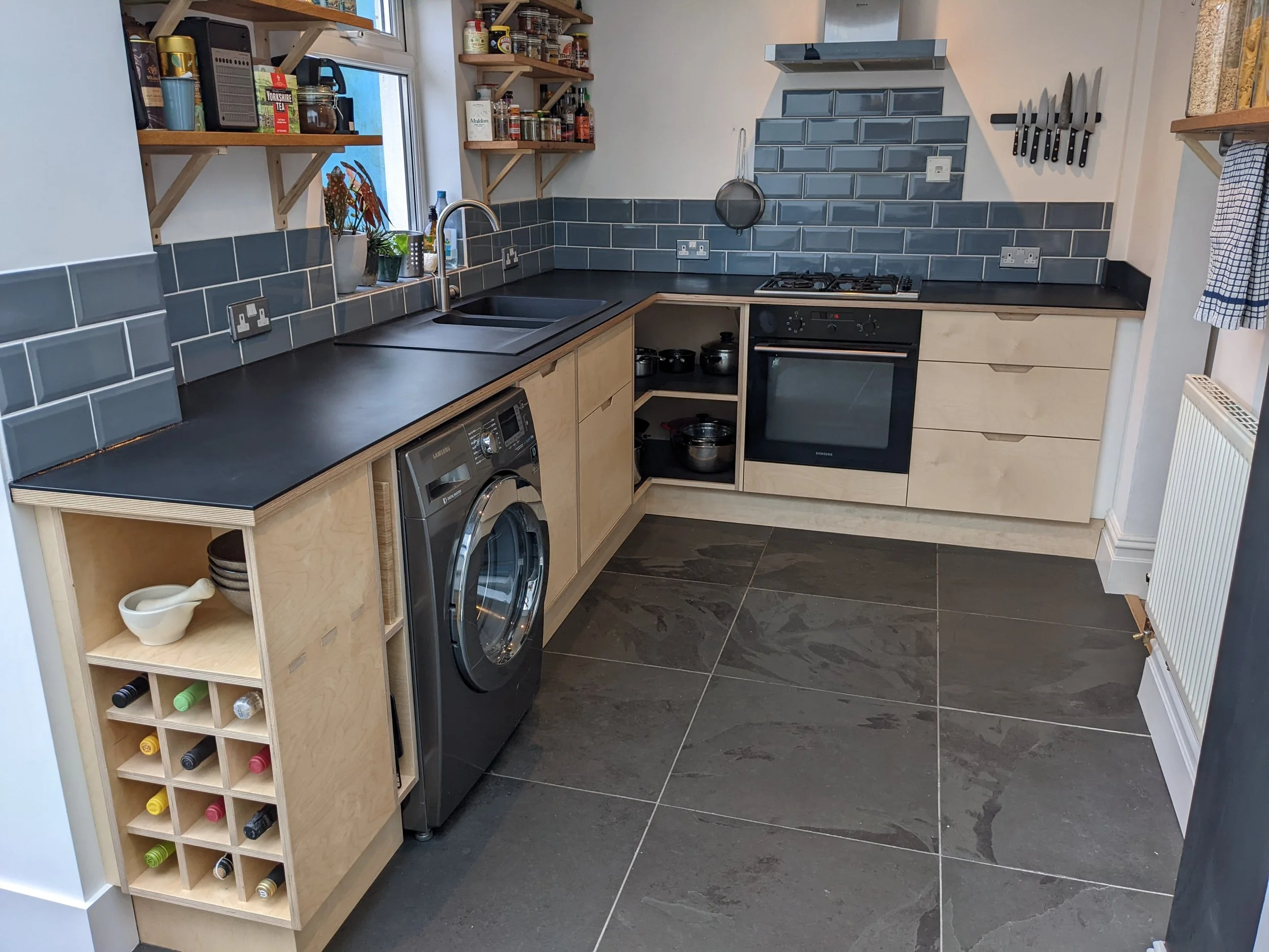 The kitchen design included built in features such as the wine rack and open shelving.