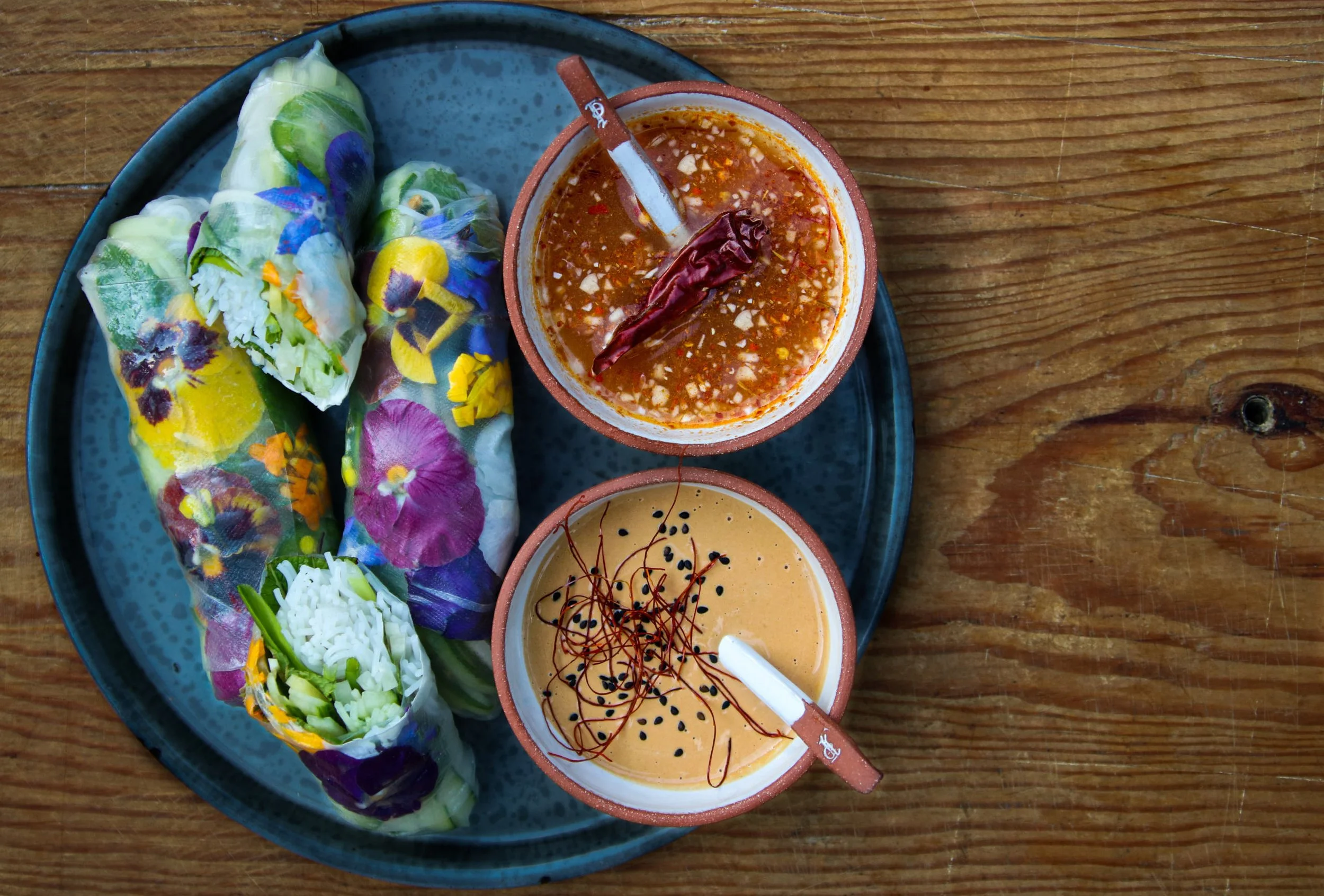 Fresh summer rolls with flowers, crab and avocado