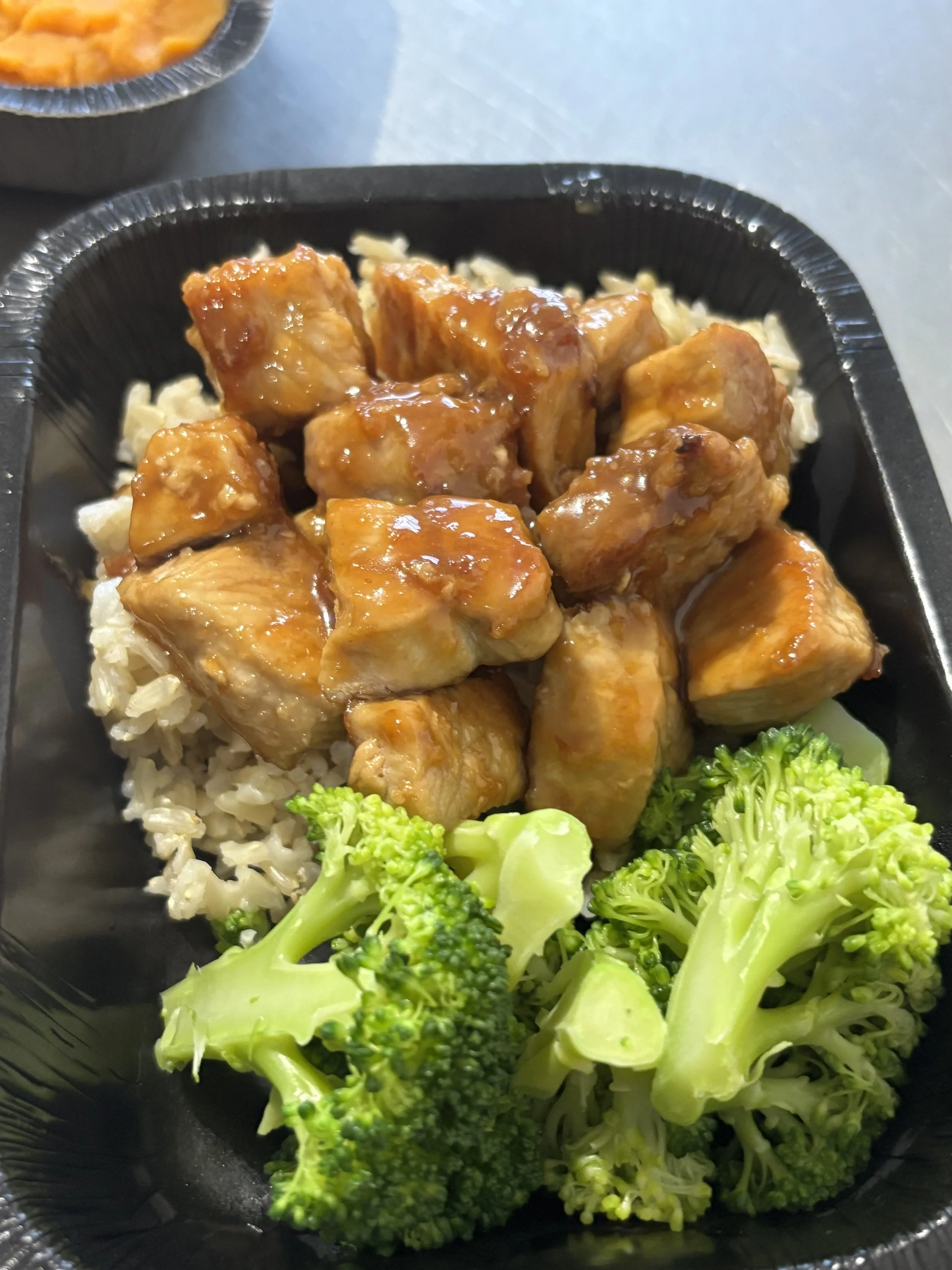 Honey Garlic Pork Bites with Broccoli and Side.
