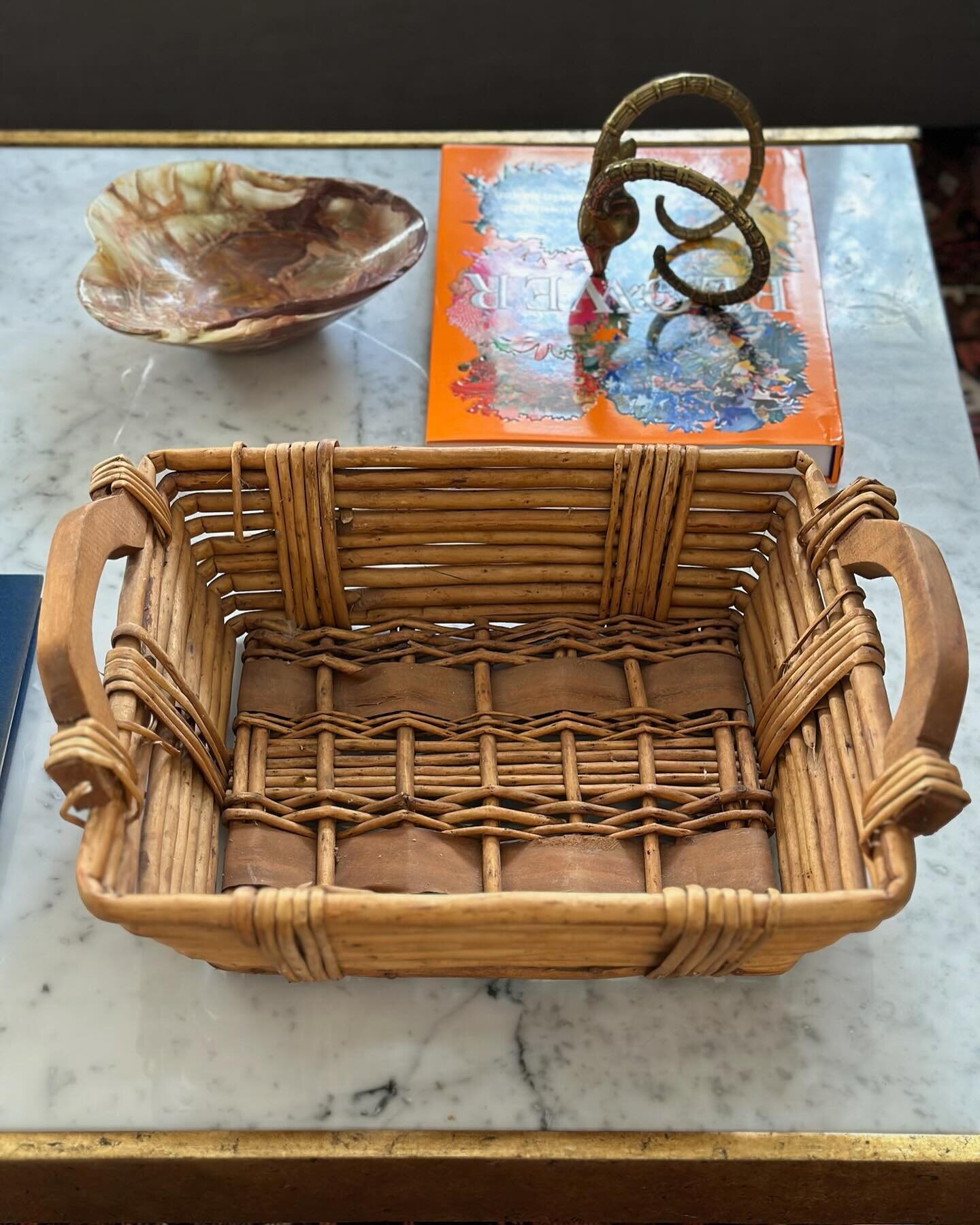 This vintage woven basket with wooden handles is the perfect table topper! Link in stories to purchase.