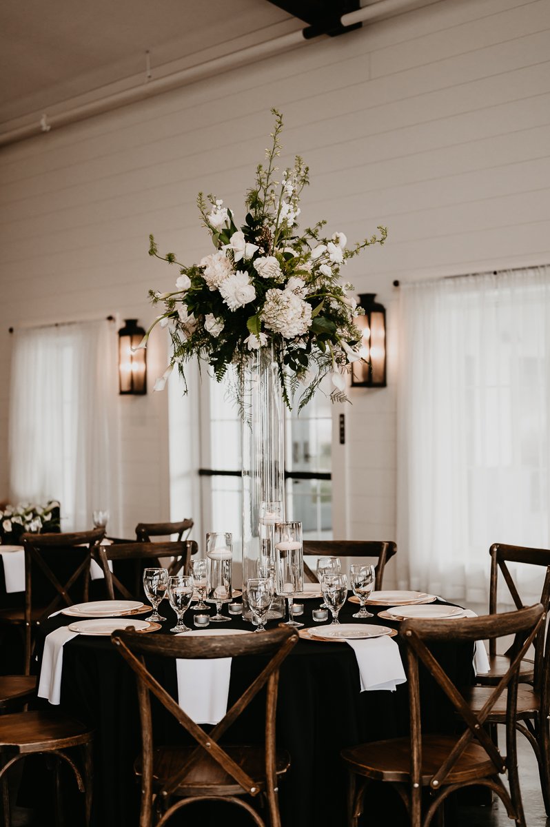Striking Table Decoration with Tall Floral Centerpiece Designed by Unique by Design at Crimson Lane Wedding Venue in Ada, Ohio captured by Julia Brown Photo