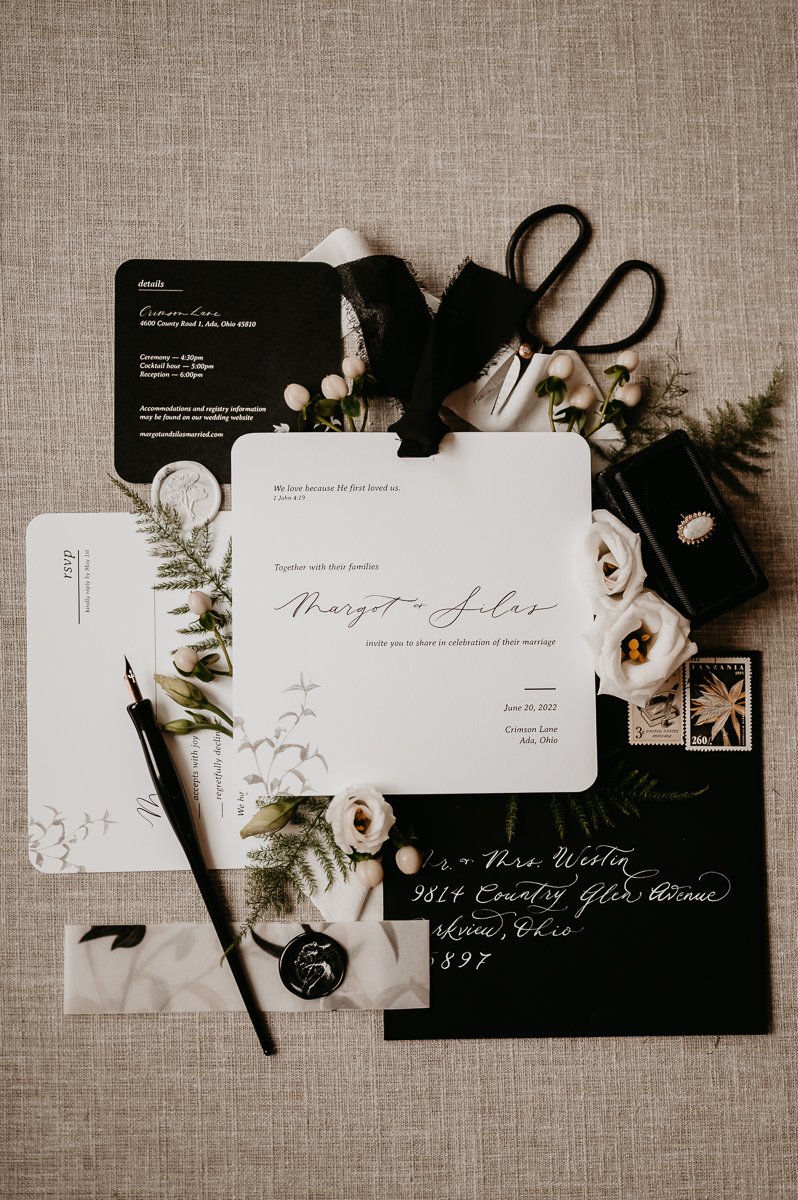 This photo, by Julia Brown Photo, showcases elegant calligraphy and unique designs by Whimsically Warm. The invitations, menus, and place cards, are displayed on a neutral background.