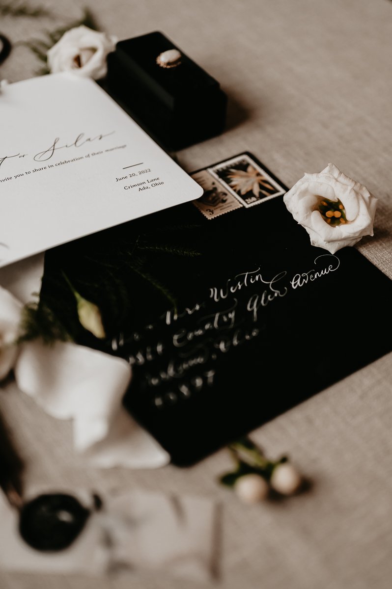Photo taken by Julia Brown Photo featuring a close-up of bespoke wedding invitation suite by Whimsically Warm.