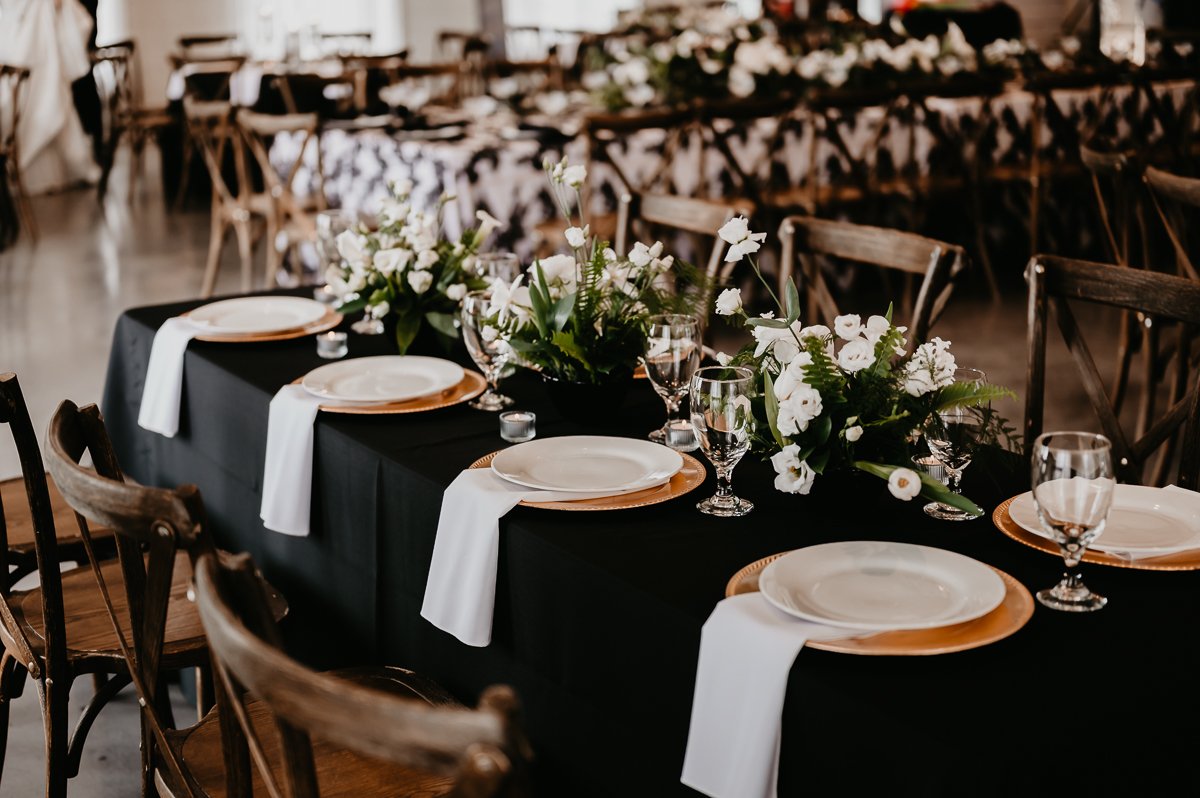 Sophisticated Tablescape Design at Crimson Lane Wedding Venue with Black Linens and Floral Centerpiece | Photo by Julia Brown Photo