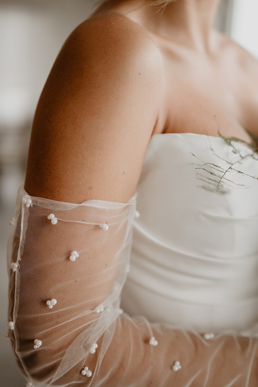 Pearl, beaded bridal gloves with a modern, strapless mermaid wedding gown