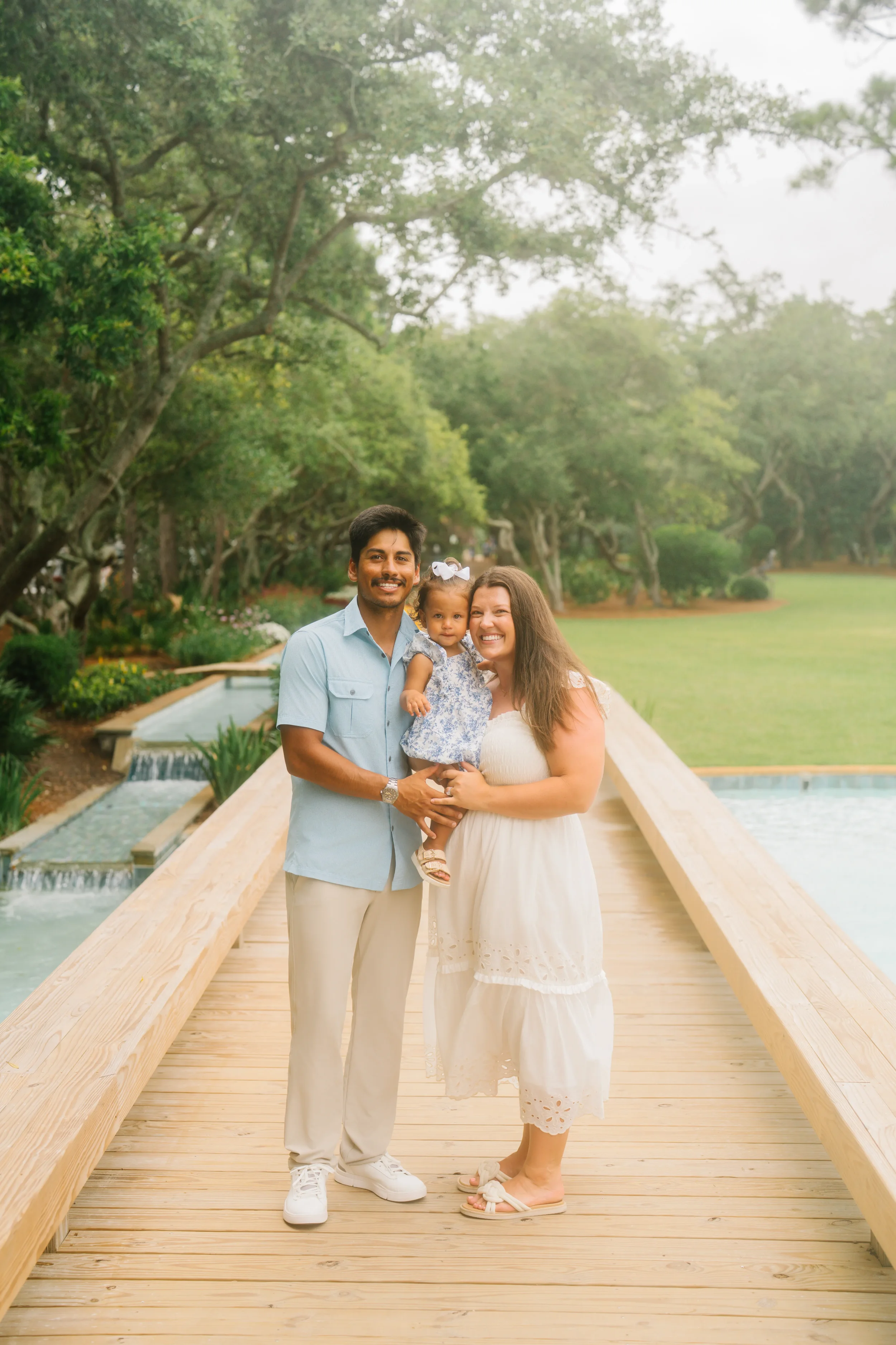 Freeport family photographer capturing a family portrait on a wooden dock