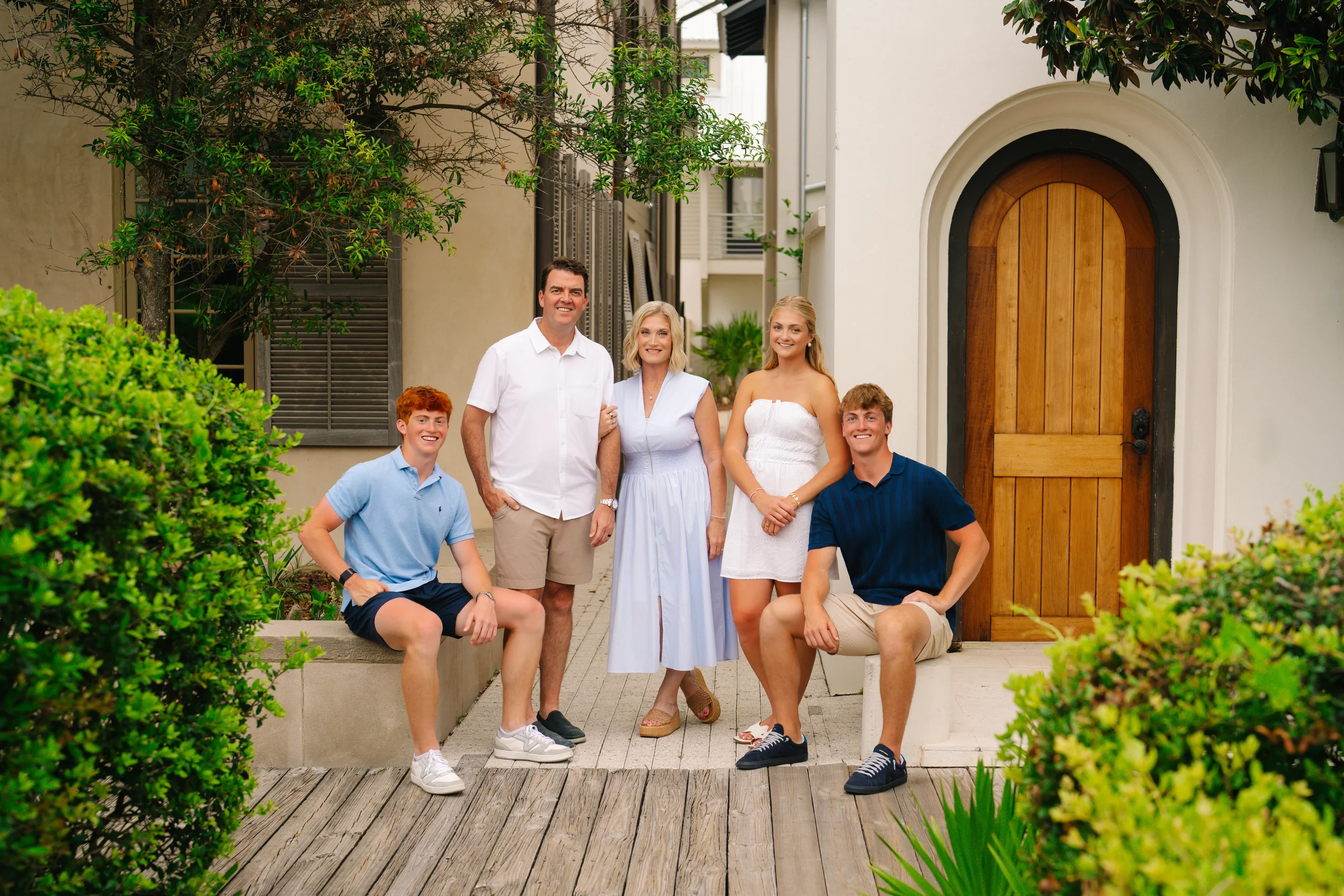 Freeport family photographer capturing a family portrait on a front porch