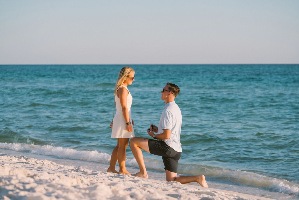 Seaside marriage proposal at sunset