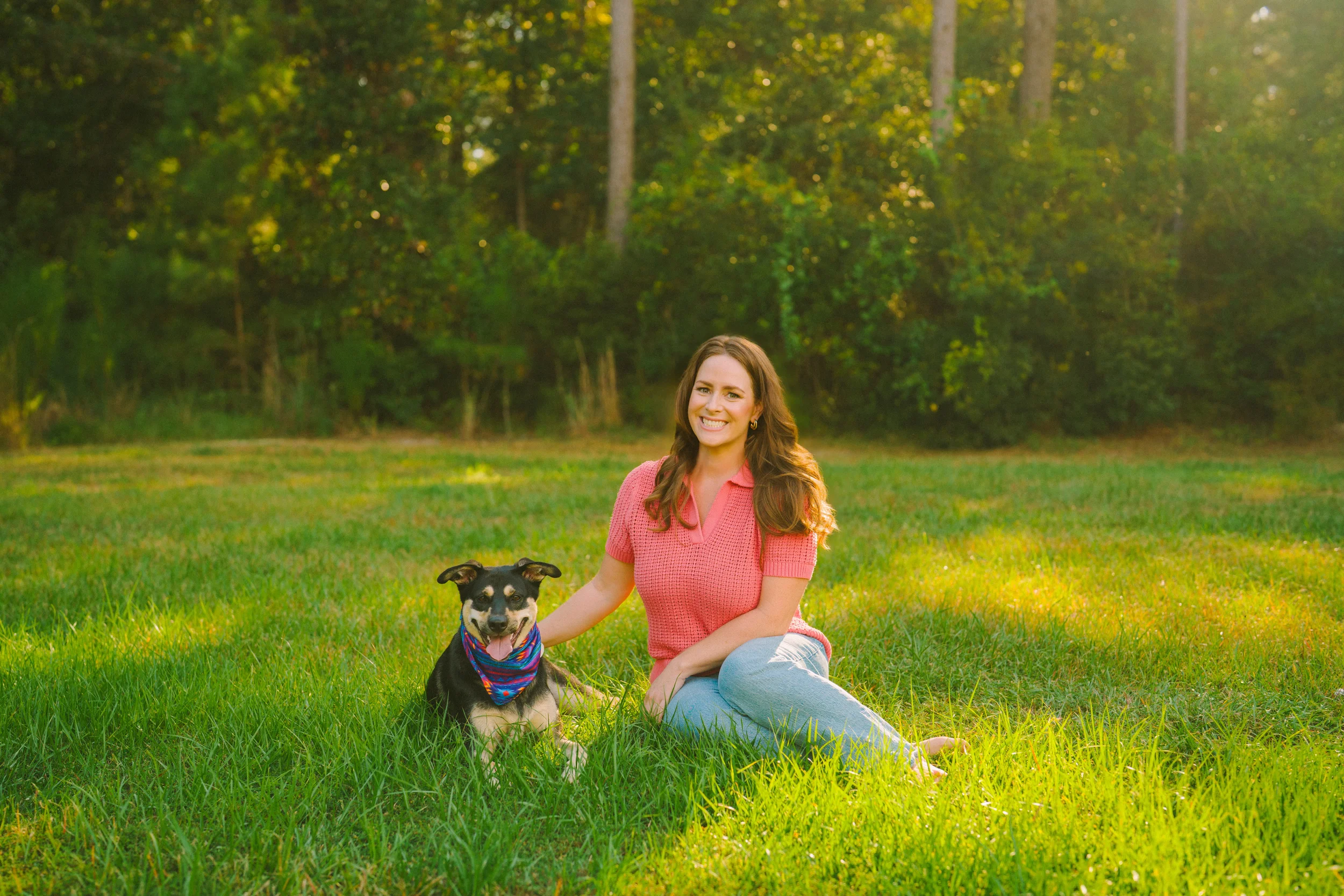 Freeport pet photographer capturing a woman and her dog outdoors in a grassy field