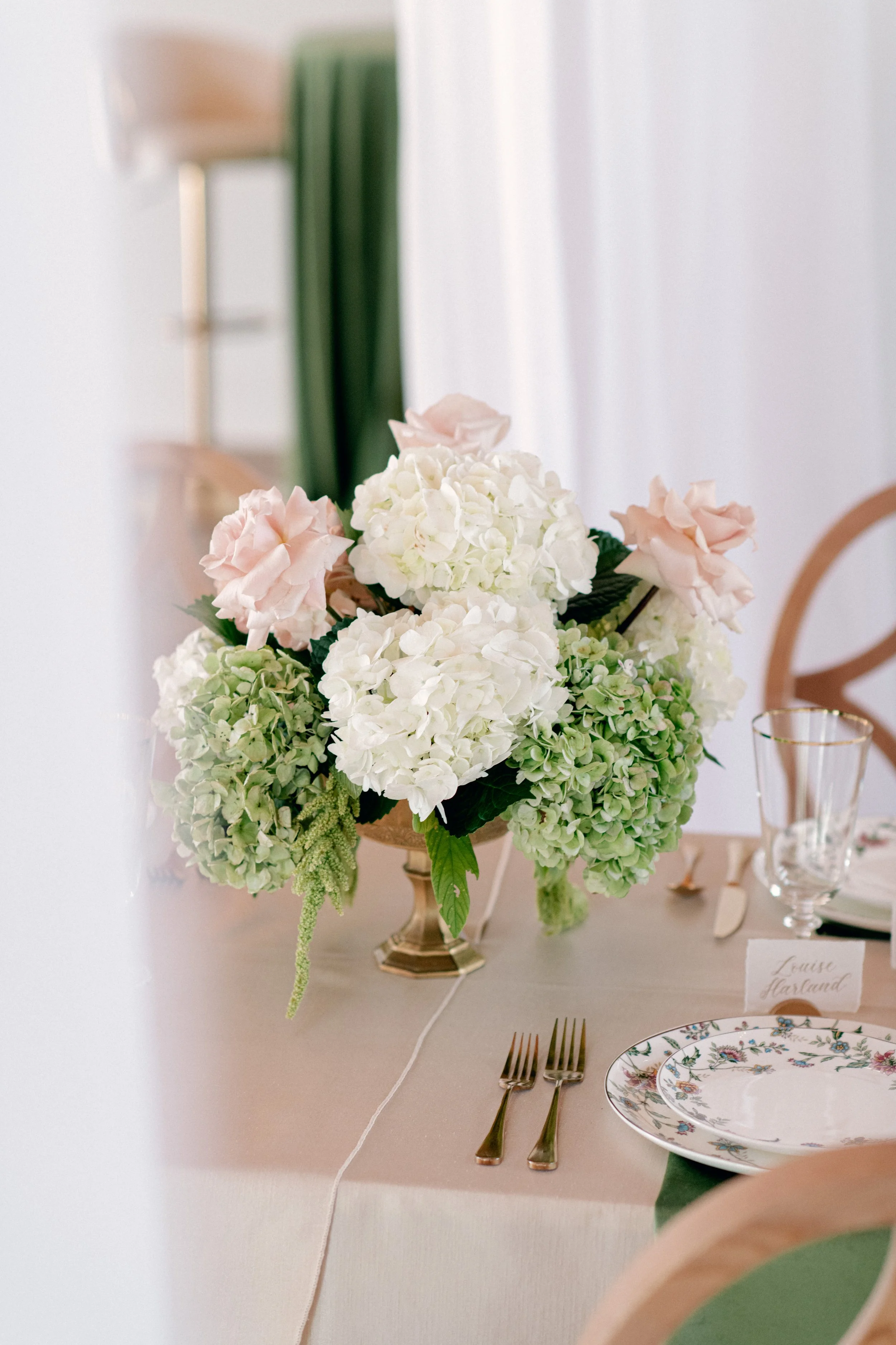 Long reception table at Jubilee Woods with maximalist floral design and calligraphy place cards