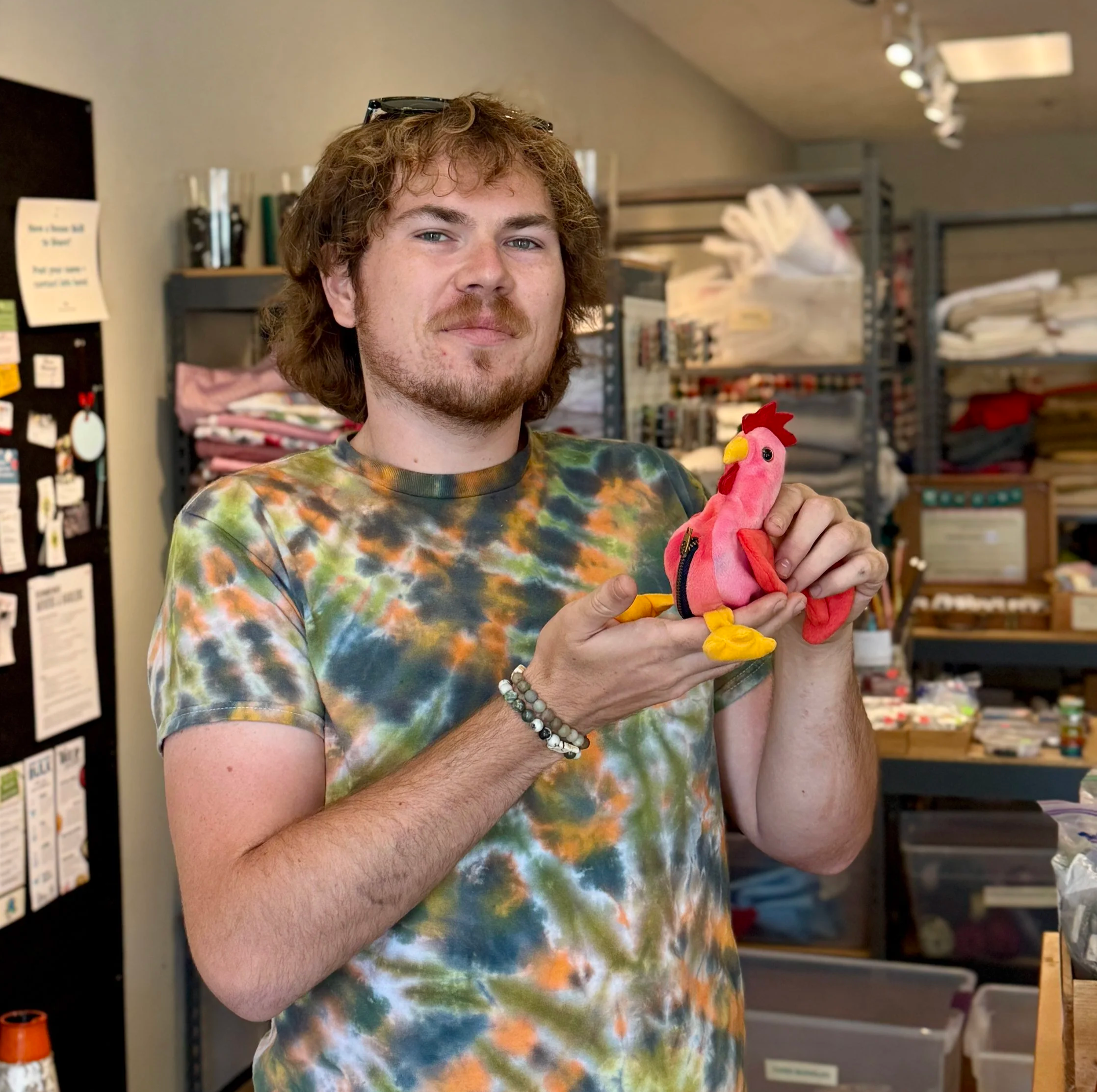 Person holding repurposed rooster beanie baby coin purse