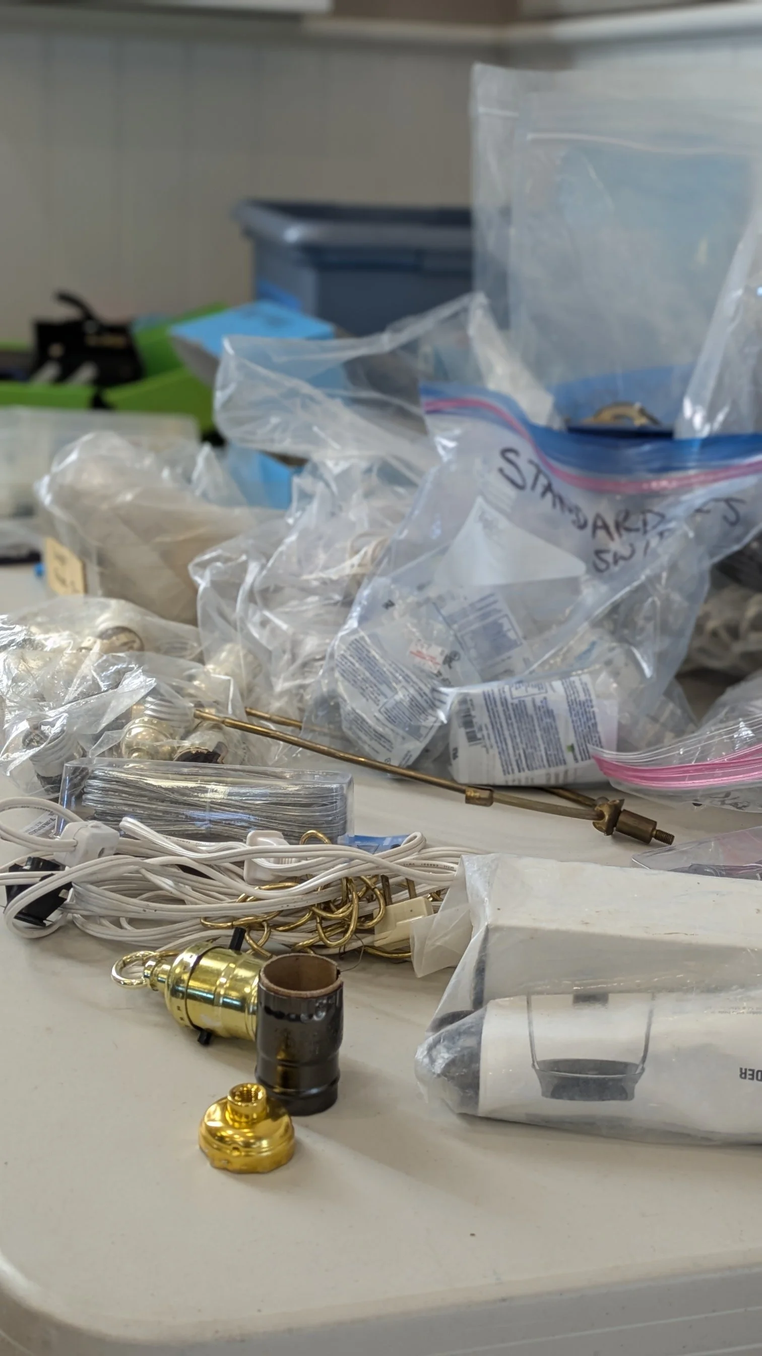 Lamp wires and brackets with plastic bags full of repair tools