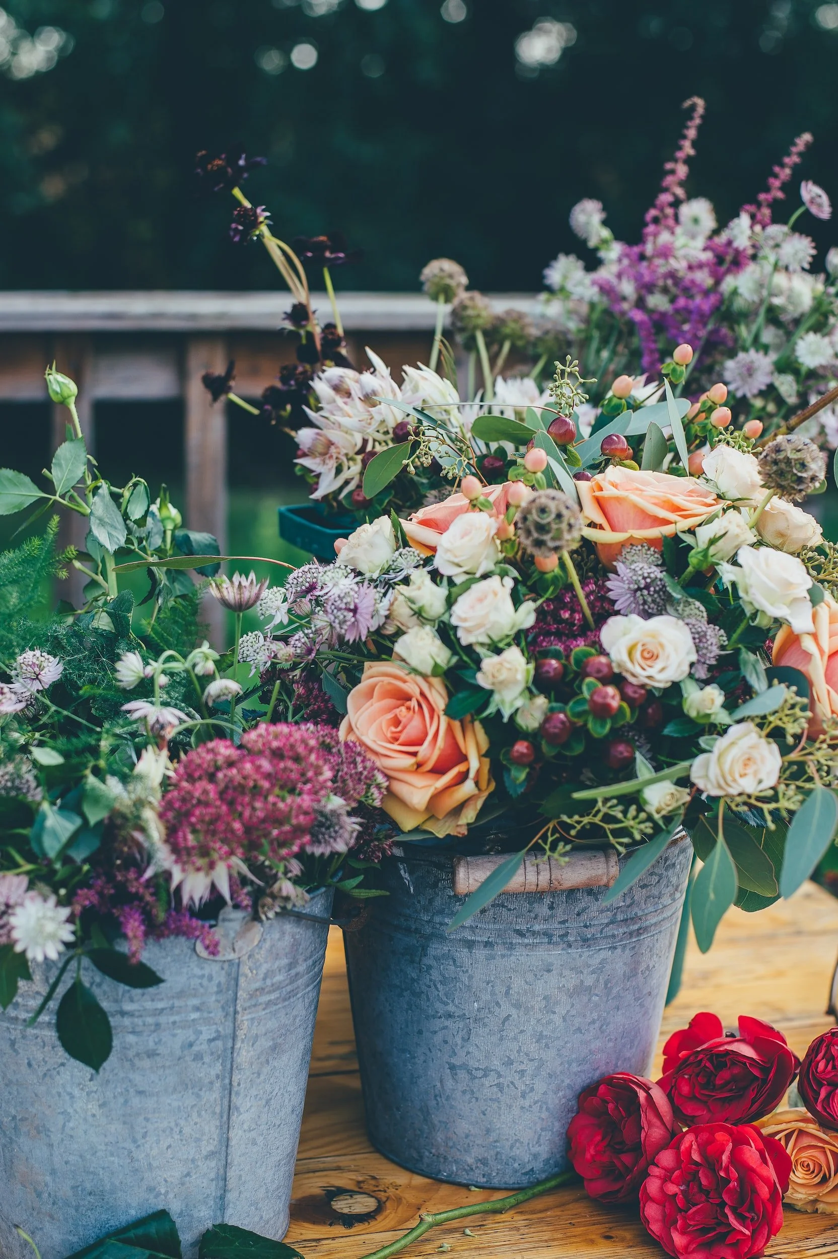 Photo by Annie Spratt on Unsplash | two buckets of flowers sitting on a deck