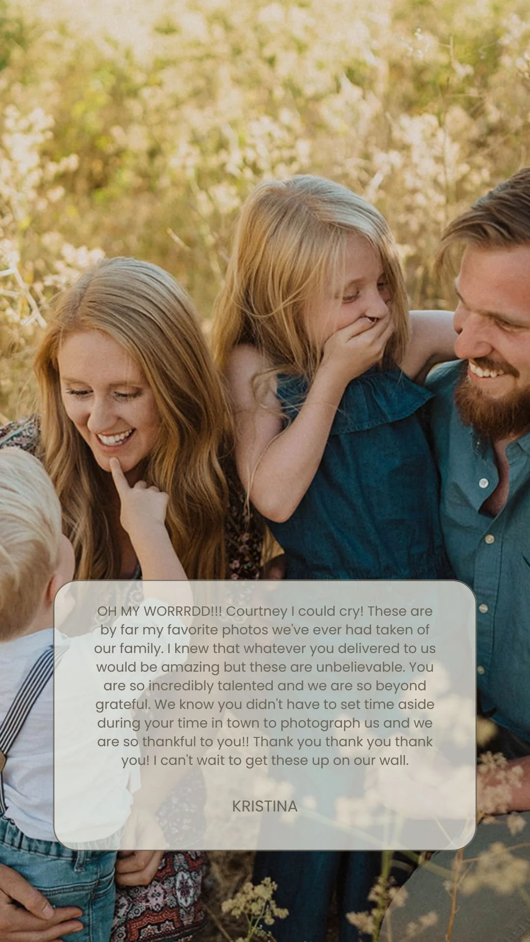 Family of four, two women, one man, and a young girl, smiling and sharing a tender moment outdoors in a sunny field of tall grass and wildflowers.
