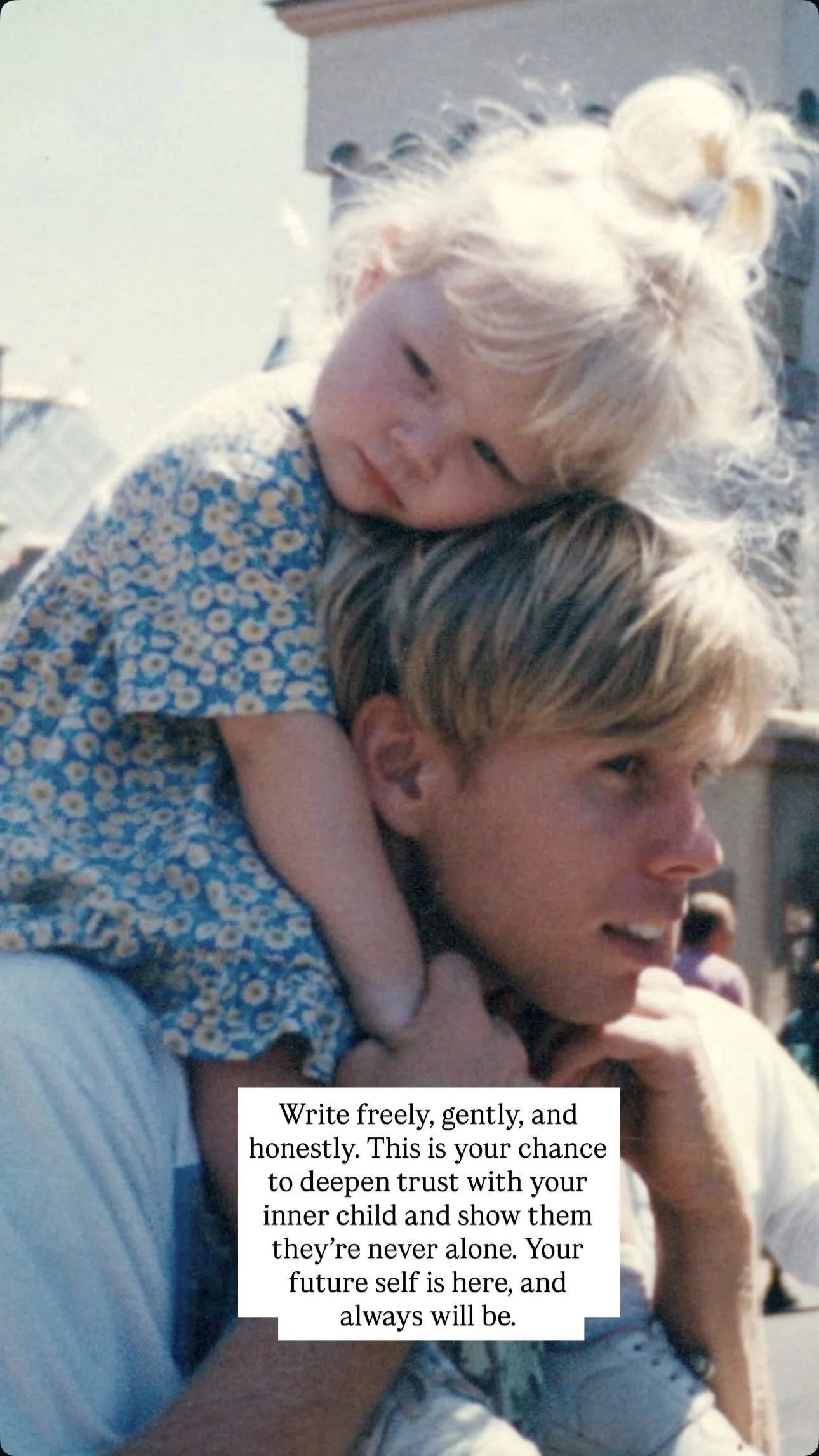 A young girl with blond hair in a small bun, wearing a blue and white daisy-patterned dress, is sitting on the shoulders of an older young man with blond hair. They are outdoors with people and buildings in the background. There is a quote overlaid o