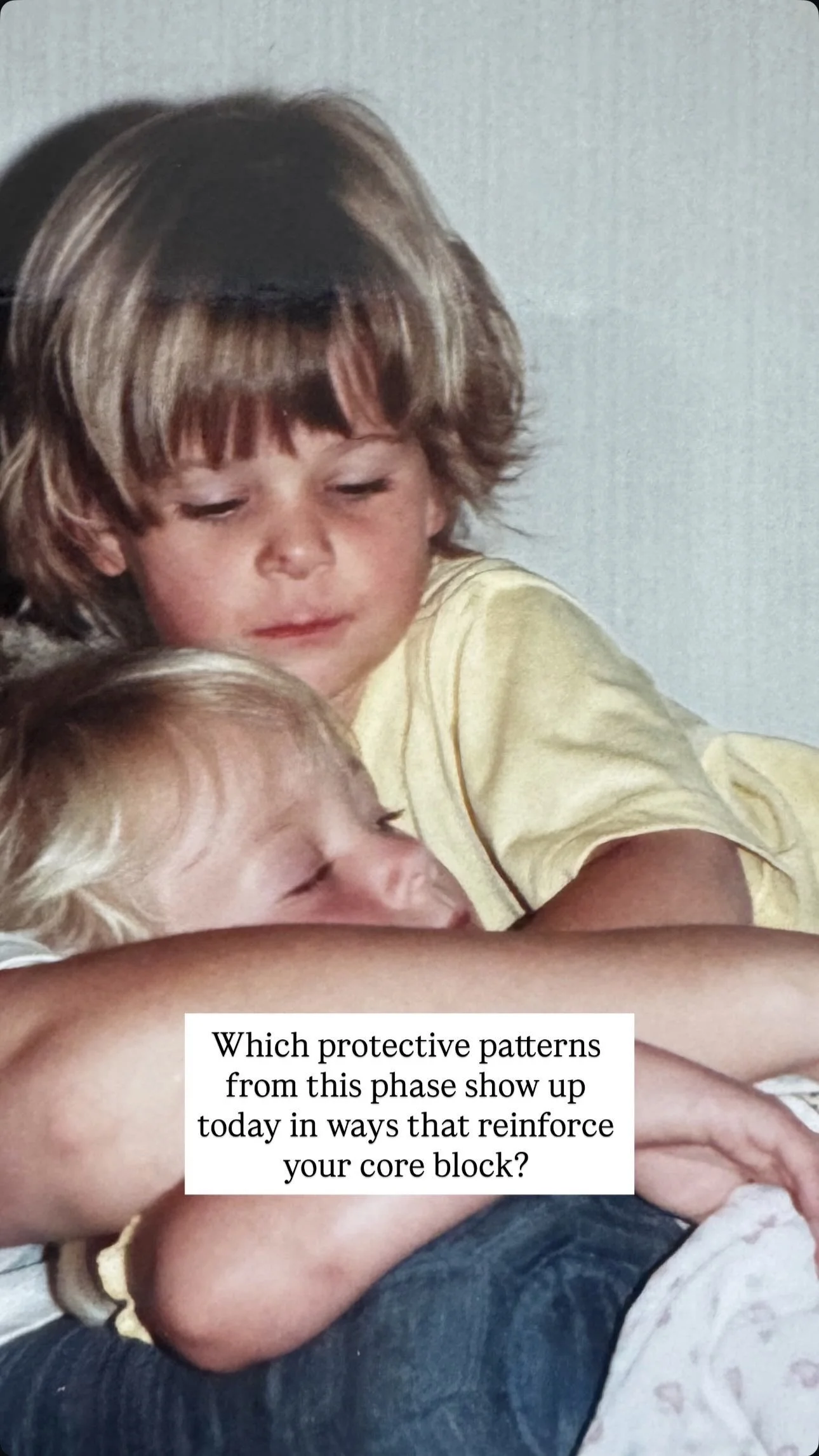 Two young children, one with closed eyes, embrace each other affectionately, with a white background.