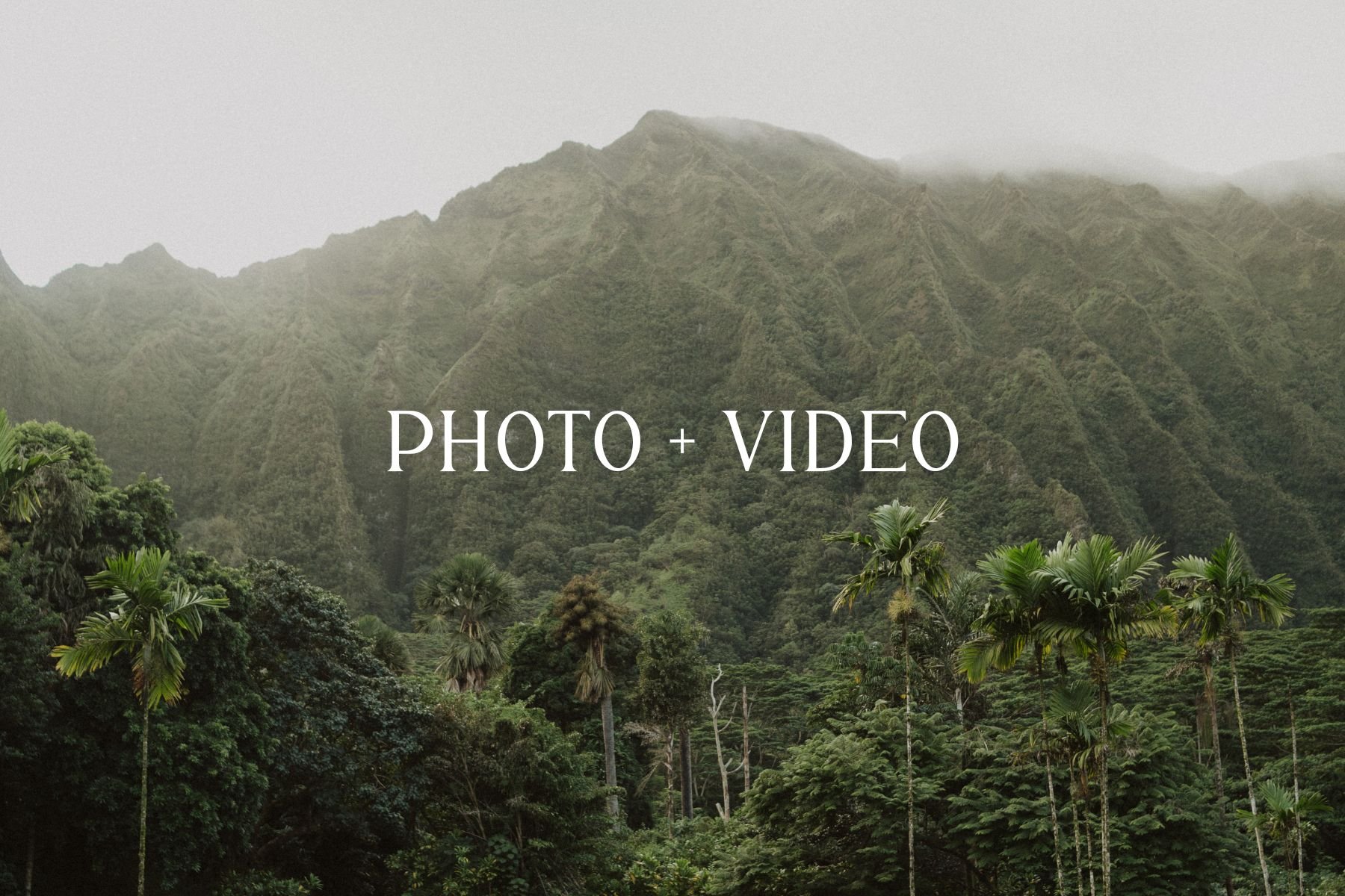 A visibly green mountain landscape with lush trees and tropical plants, with mist or fog at the mountain peaks. Overlaid text reads 'PHOTO + VIDEO'.