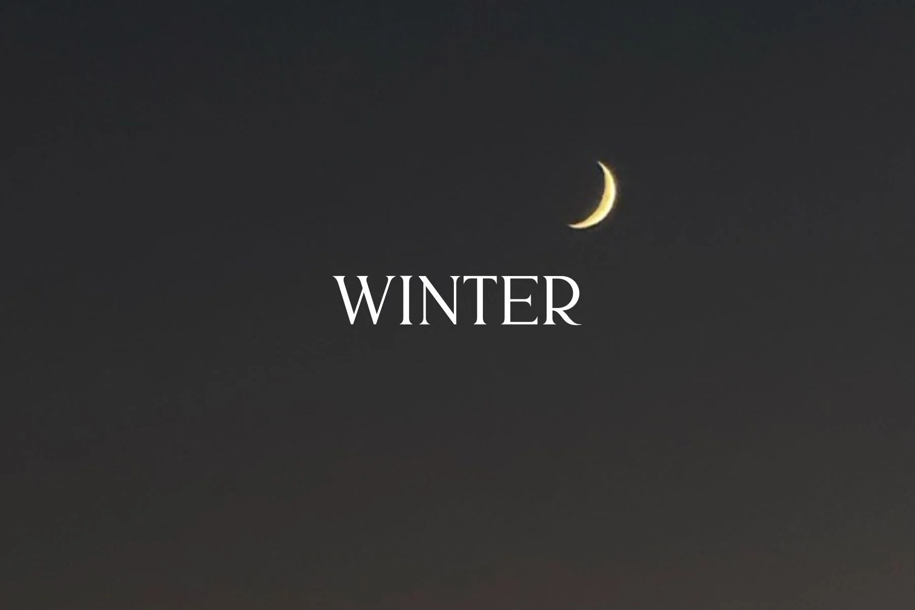 A dark twilight sky with a slender crescent moon and the word "WINTER" in white text.