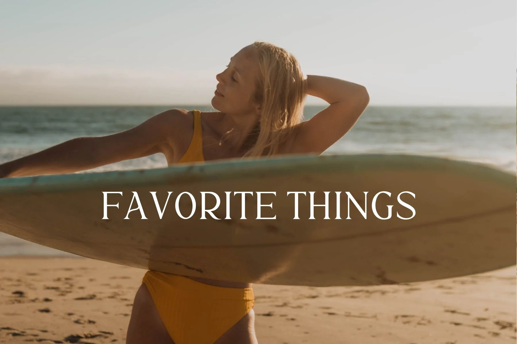 Woman in yellow swimsuit holding surfboard on beach during sunset, with text 'Favorite Things' overlayed