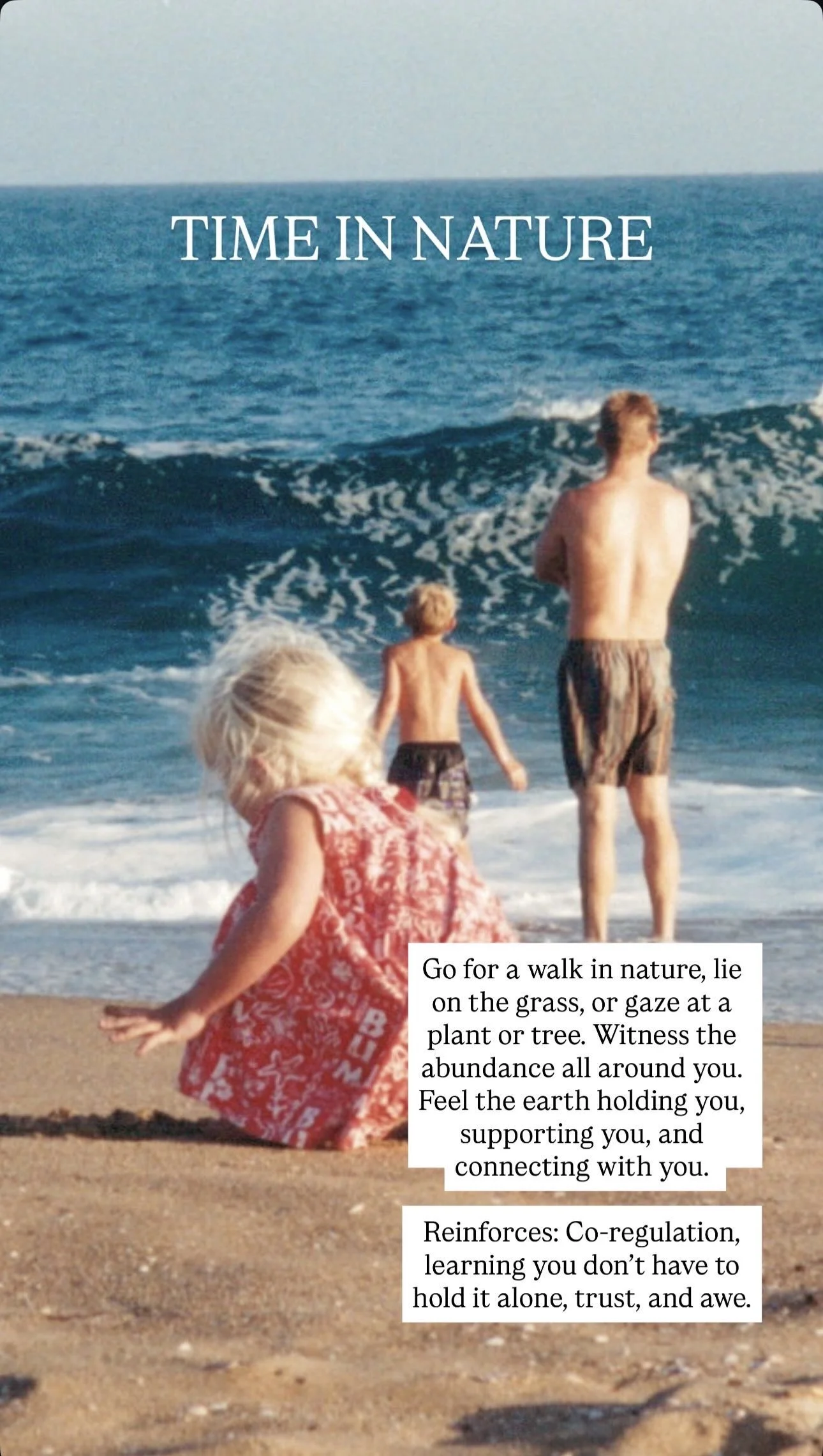 Children playing on a sandy beach with waves in the background. One child is sitting on the sand in a red dress, and two children are standing closer to the water, one adult and one child, with an ocean and blue sky in the background.