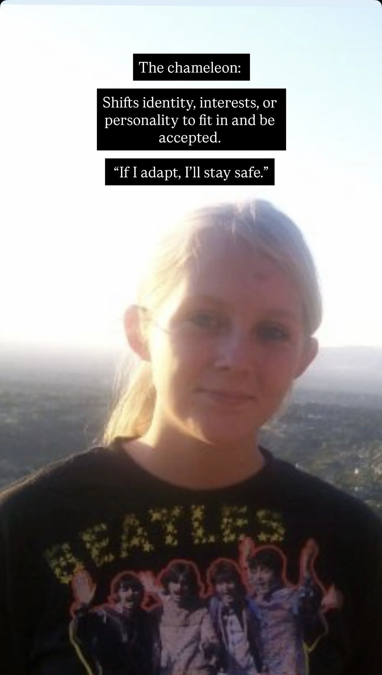 A young woman with blonde hair pulled back, wearing a black T-shirt with a band graphic, standing outdoors in a natural landscape during sunset. There is a quote at the top about the chameleon.