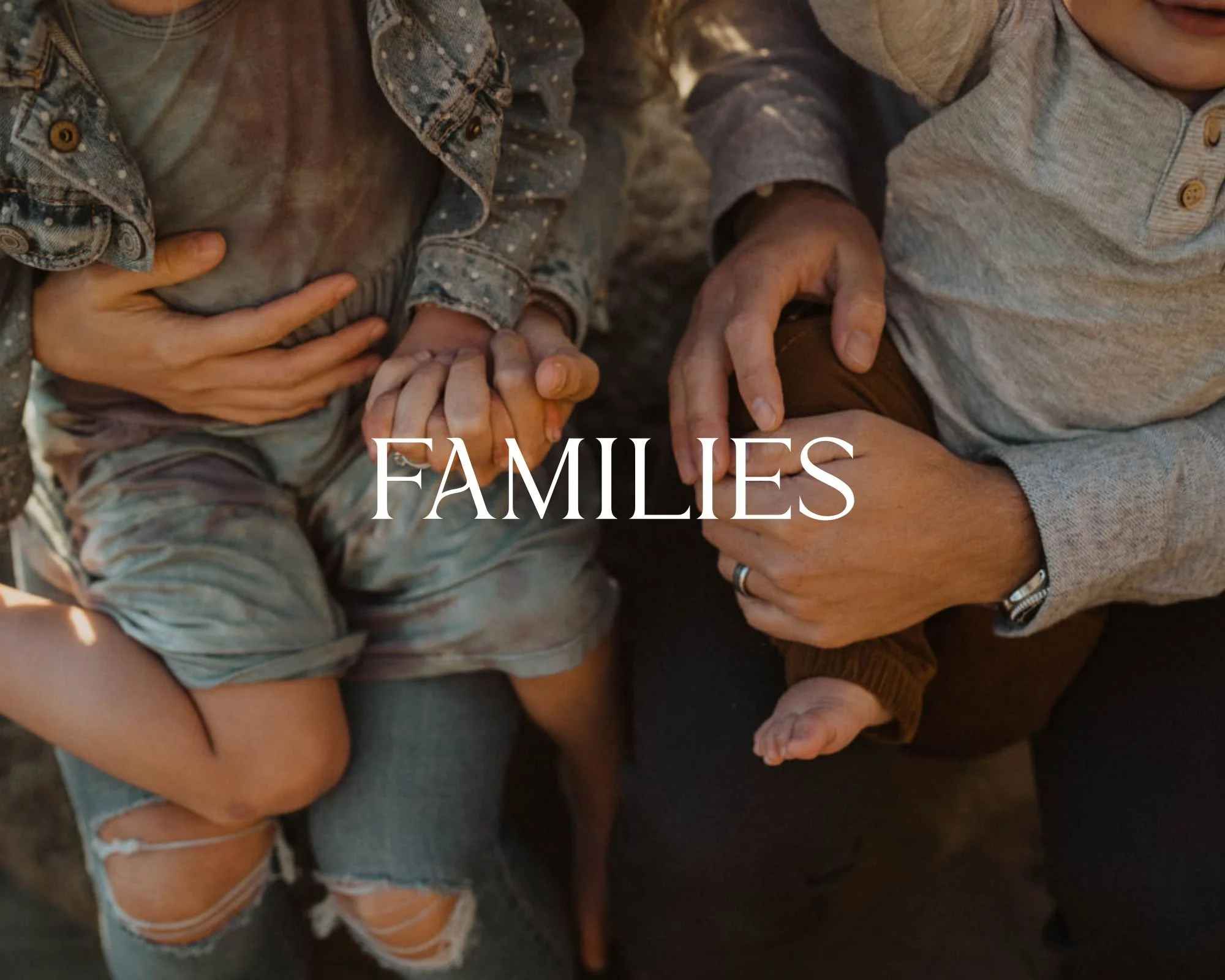 A person holding a child's hand, another adult helping hold a baby, with the word 'FAMILIES' overlaid.