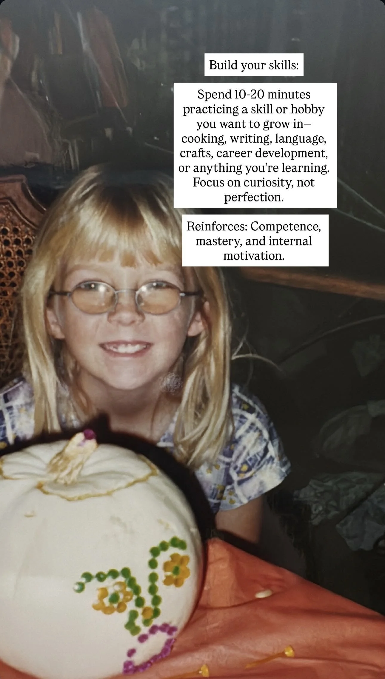 A young girl with blonde hair, glasses, and a big smile, sitting at a table with a decorated pumpkin in front of her. The pumpkin has colorful floral patterns painted on it. There are two white text boxes with instructions about building skills, prac