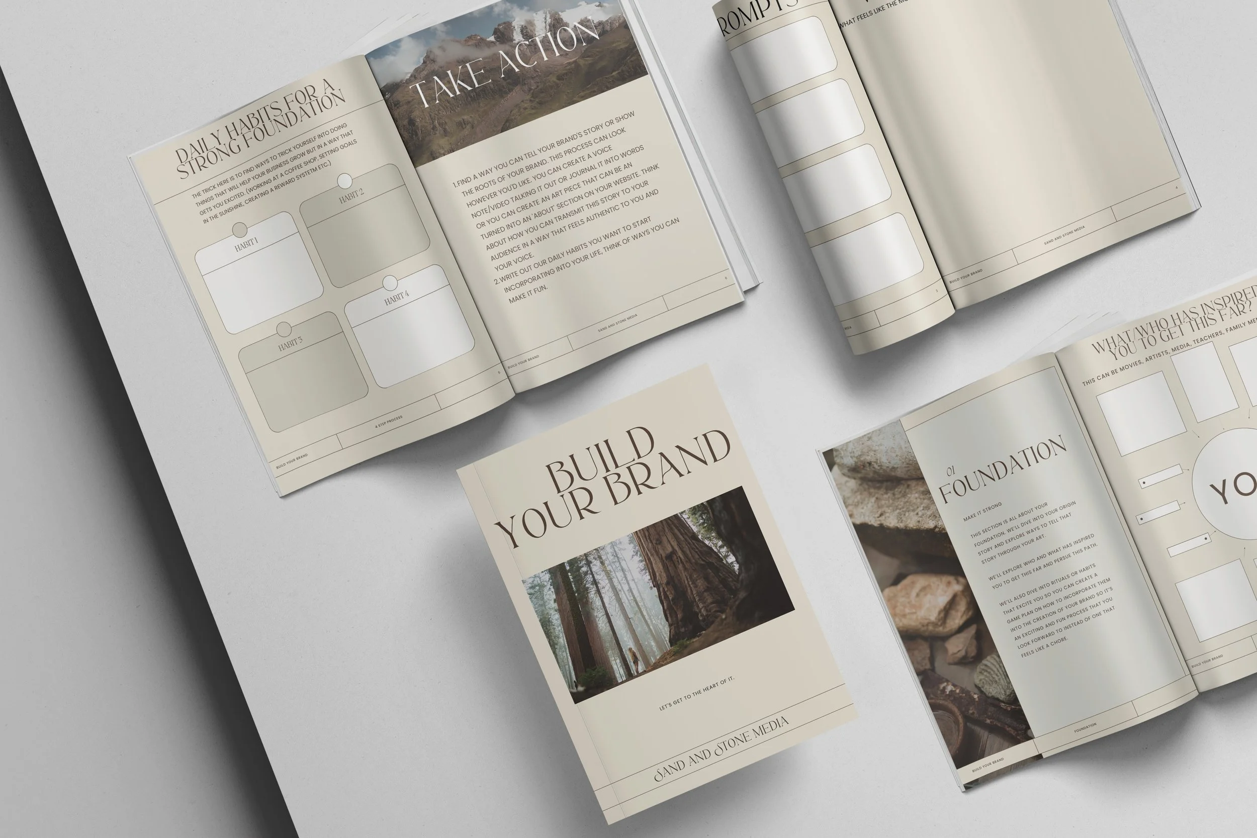Several open booklets or brochures on a light surface, featuring sections on building a brand, daily habits for a strong foundation, and personal inspiration. Some pages include text, headers, and images of nature and rocks.