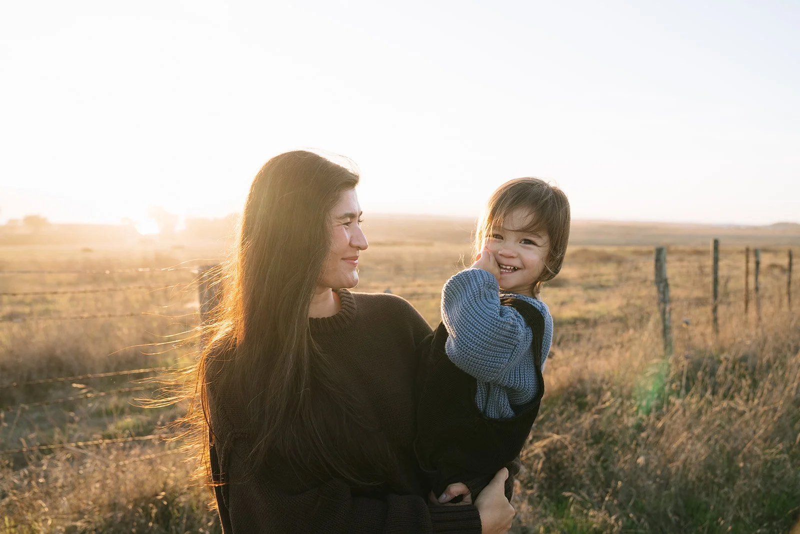Little boy smiling at the camera during sunset photoshoot