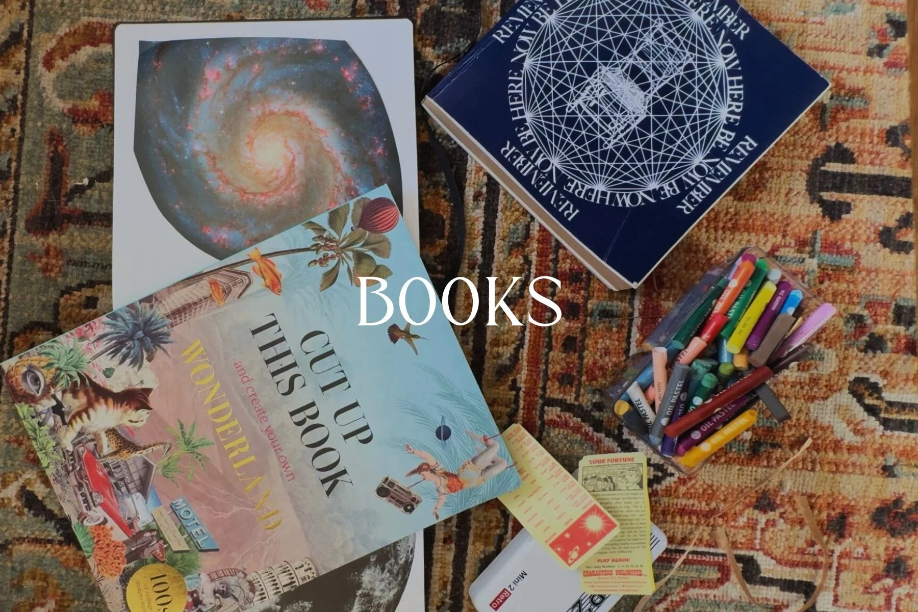 A collection of books, colorful markers, and various papers scattered on a patterned rug.