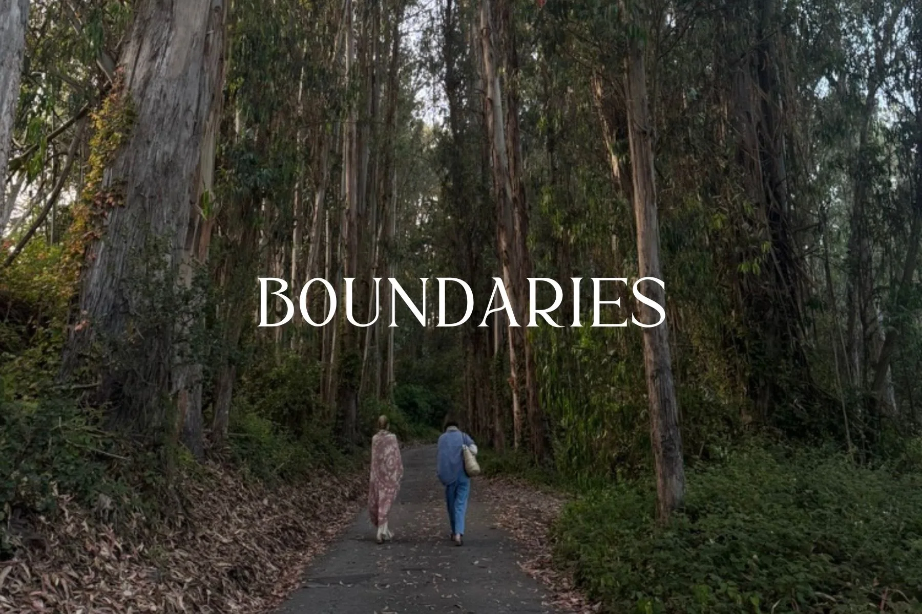 Two people walking on a forest trail surrounded by tall trees with the word 'Boundaries' overlaid on the image.