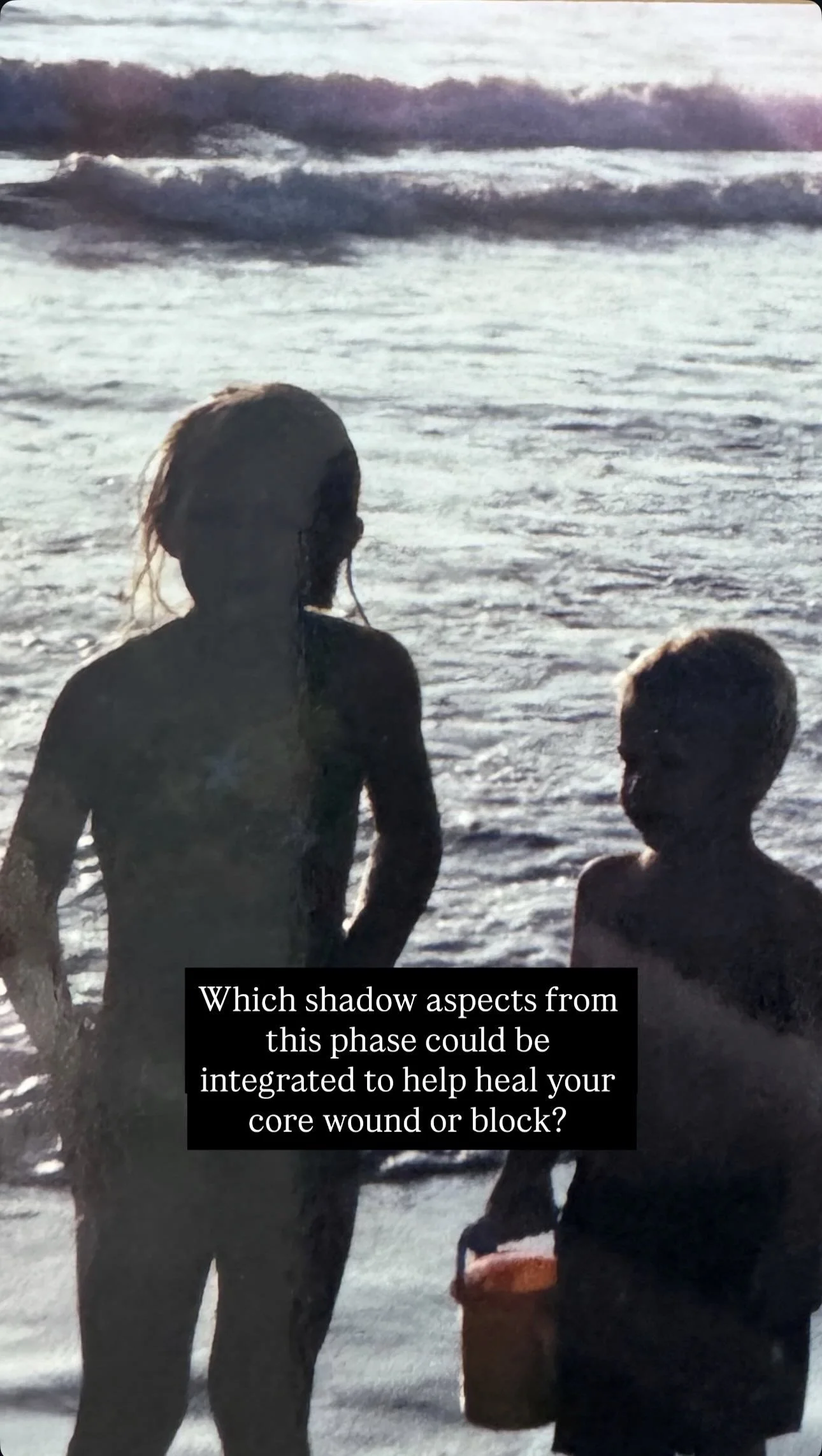 Silhouettes of two children playing in the water at the beach during sunset with waves in the background. Overlaid text reads: "Which shadow aspects from this phase could be integrated to help heal your core wound or block?"