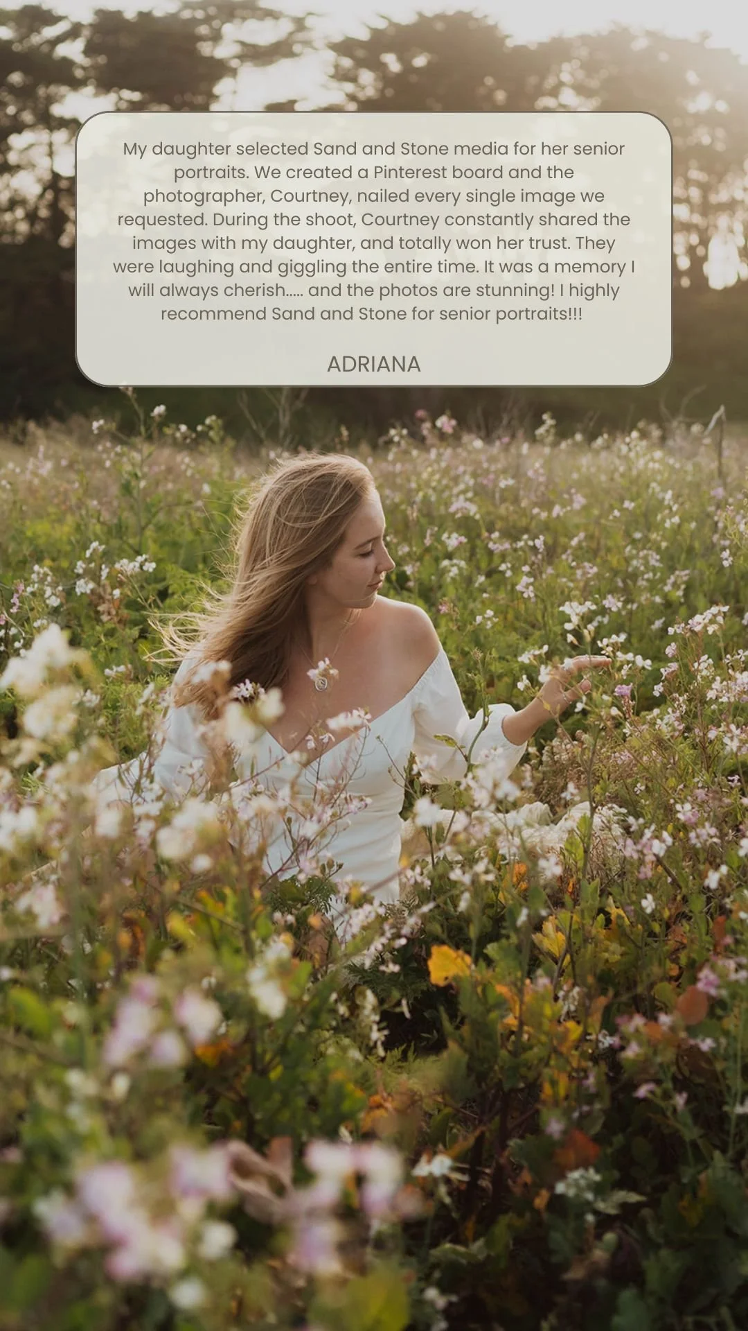 A young woman in a white off-the-shoulder dress standing in a field of flowers during sunset, with a testimonial overlay about a photoshoot experience.