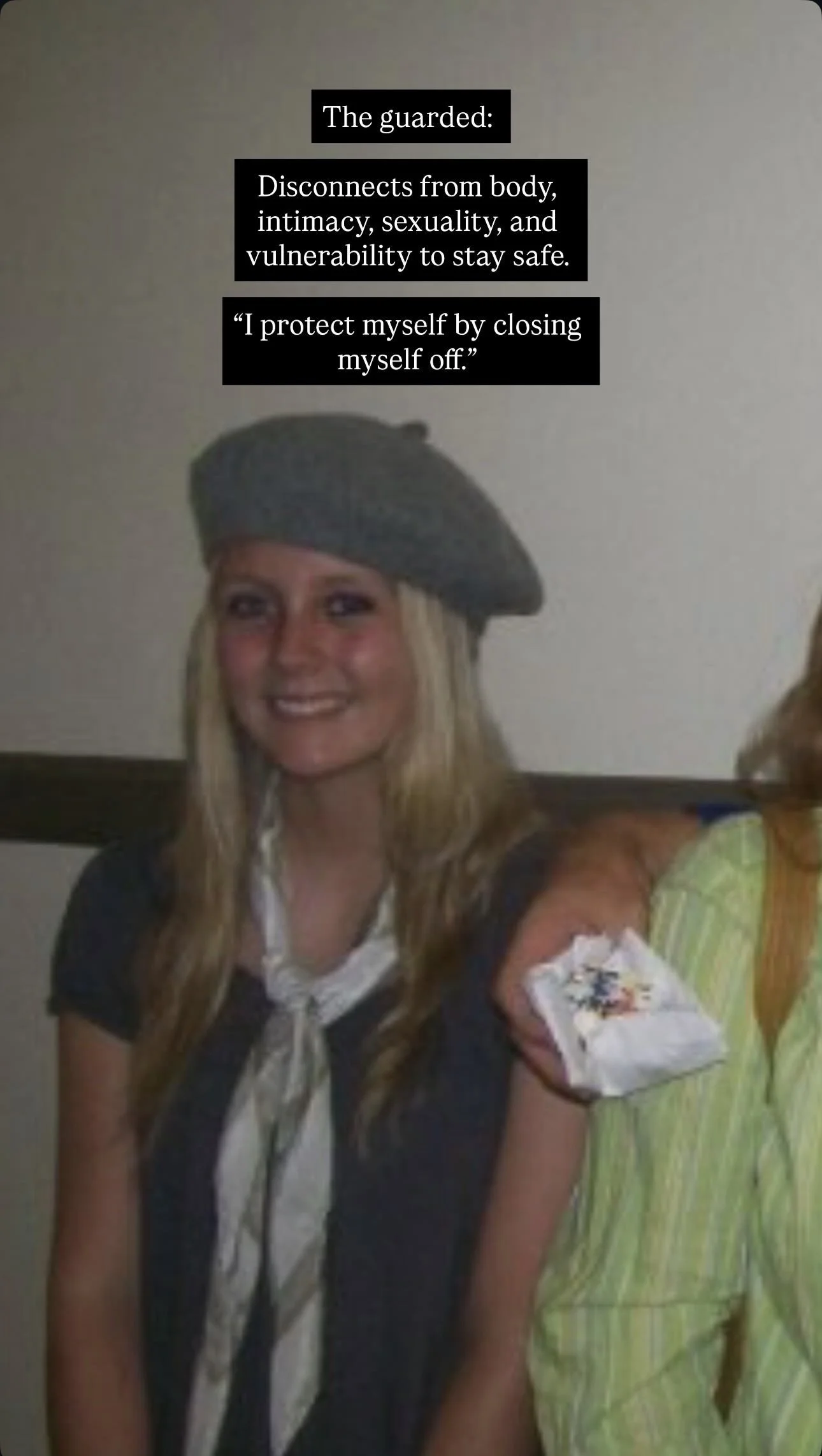 A person with blonde hair wearing a grey beret, smiling, and wearing a black shirt with a scarf. There is a bandage on their right arm with an intravenous line. Text overlay explaining the concept of a guard who disconnects from body, intimacy, sexua