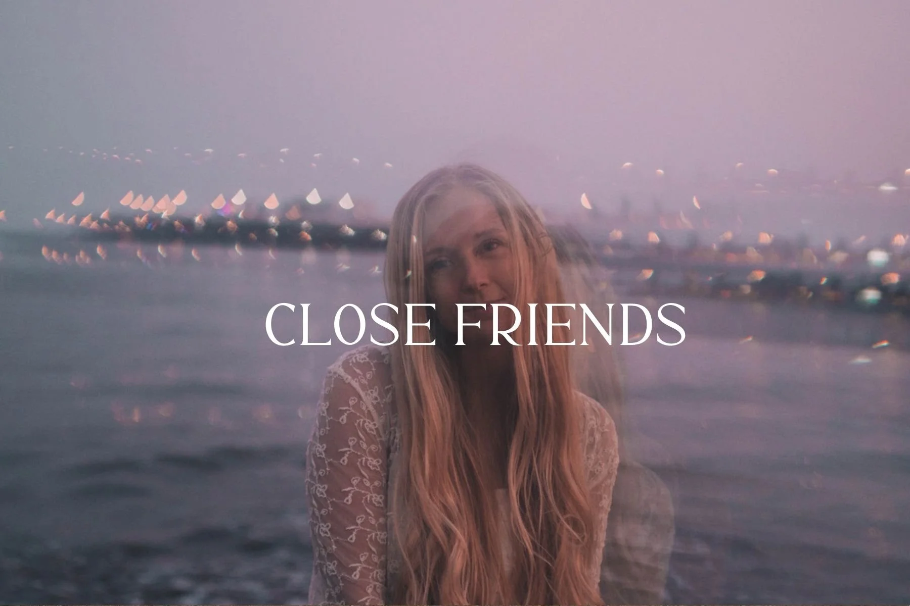 A young woman with long blonde hair and a lace top standing by the water at sunset, with city lights in the background and the words "Close Friends" overlaid.