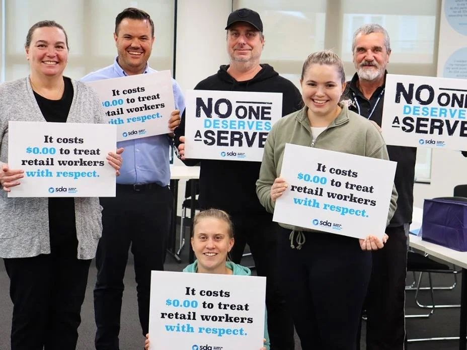 Union members with campaign placards with slogan such as "it costs $0.00 to treat retail workers with respect."