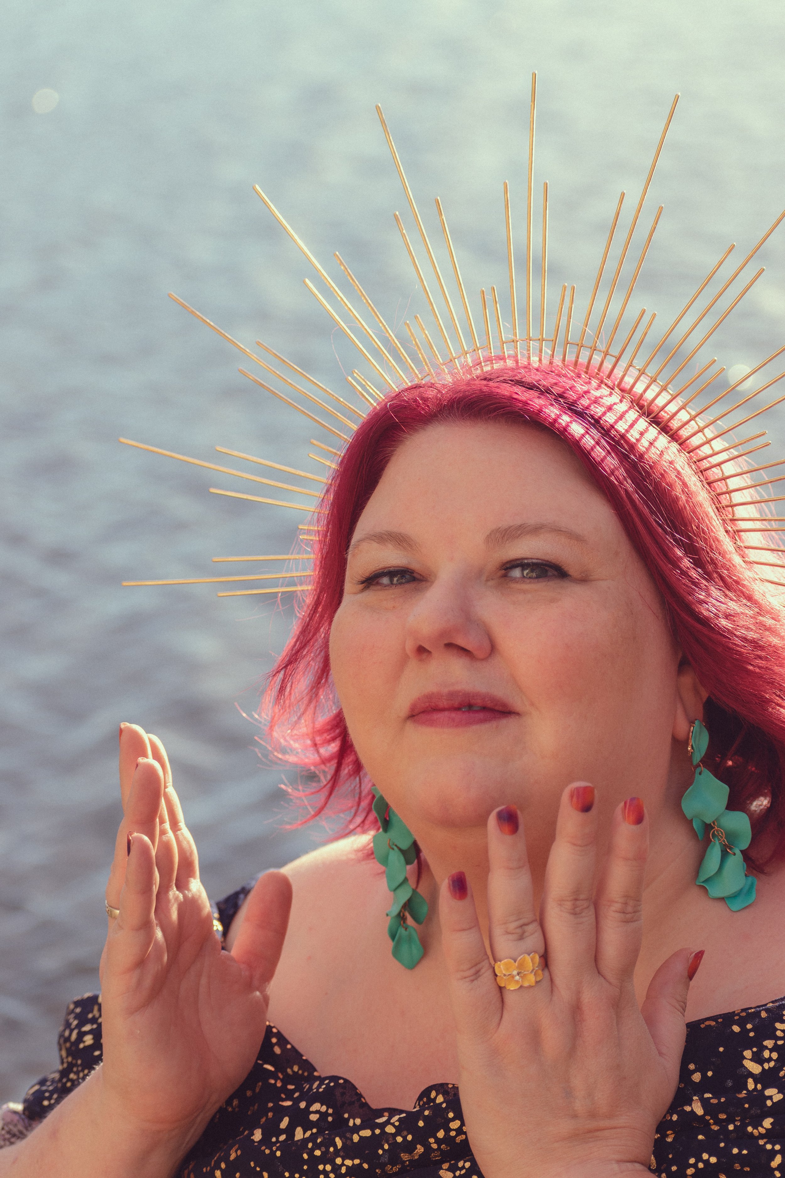 woman near water with goddess crown