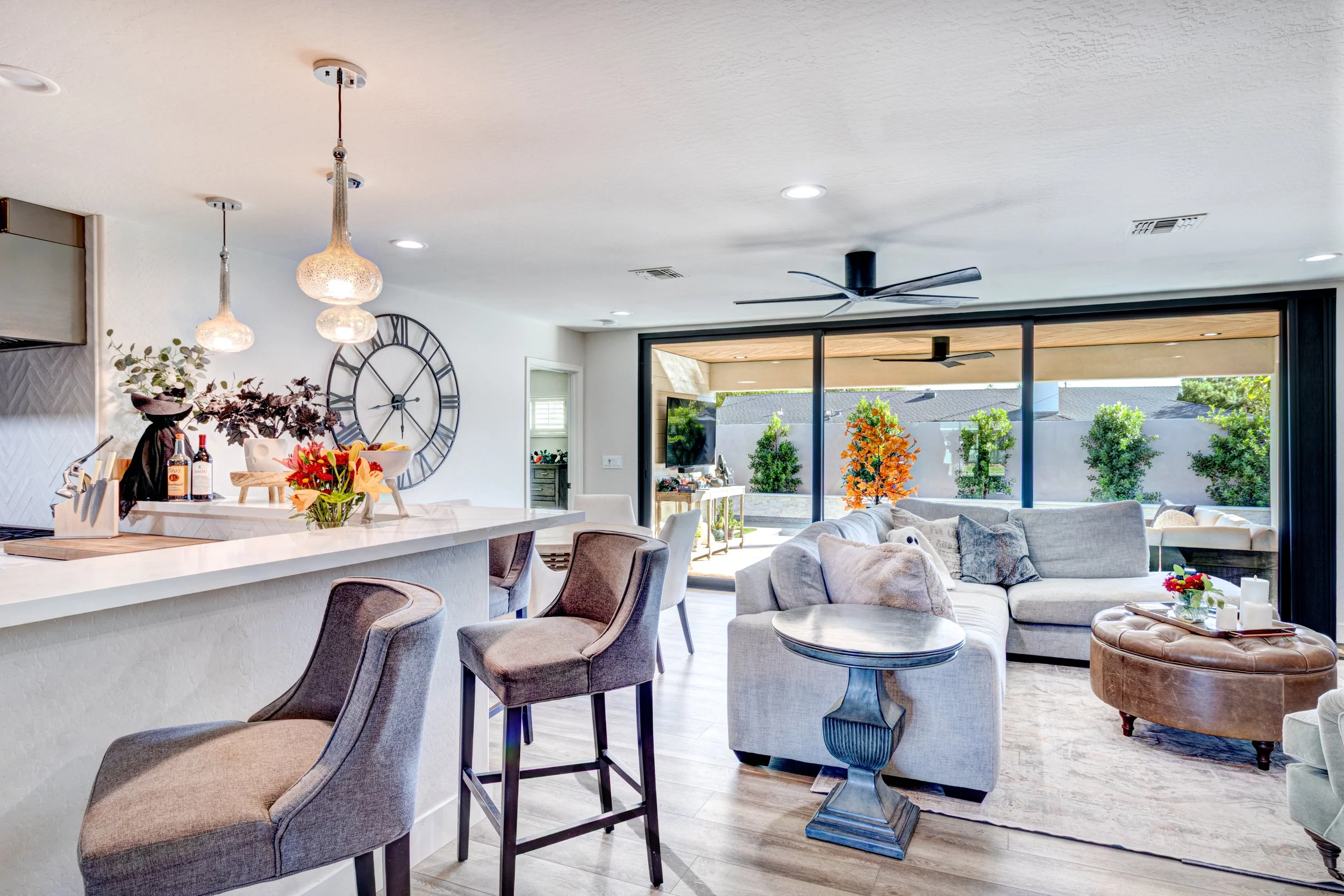 Phoenix home interior with large sliding glass doors connecting the kitchen and living area to a covered backyard patio.