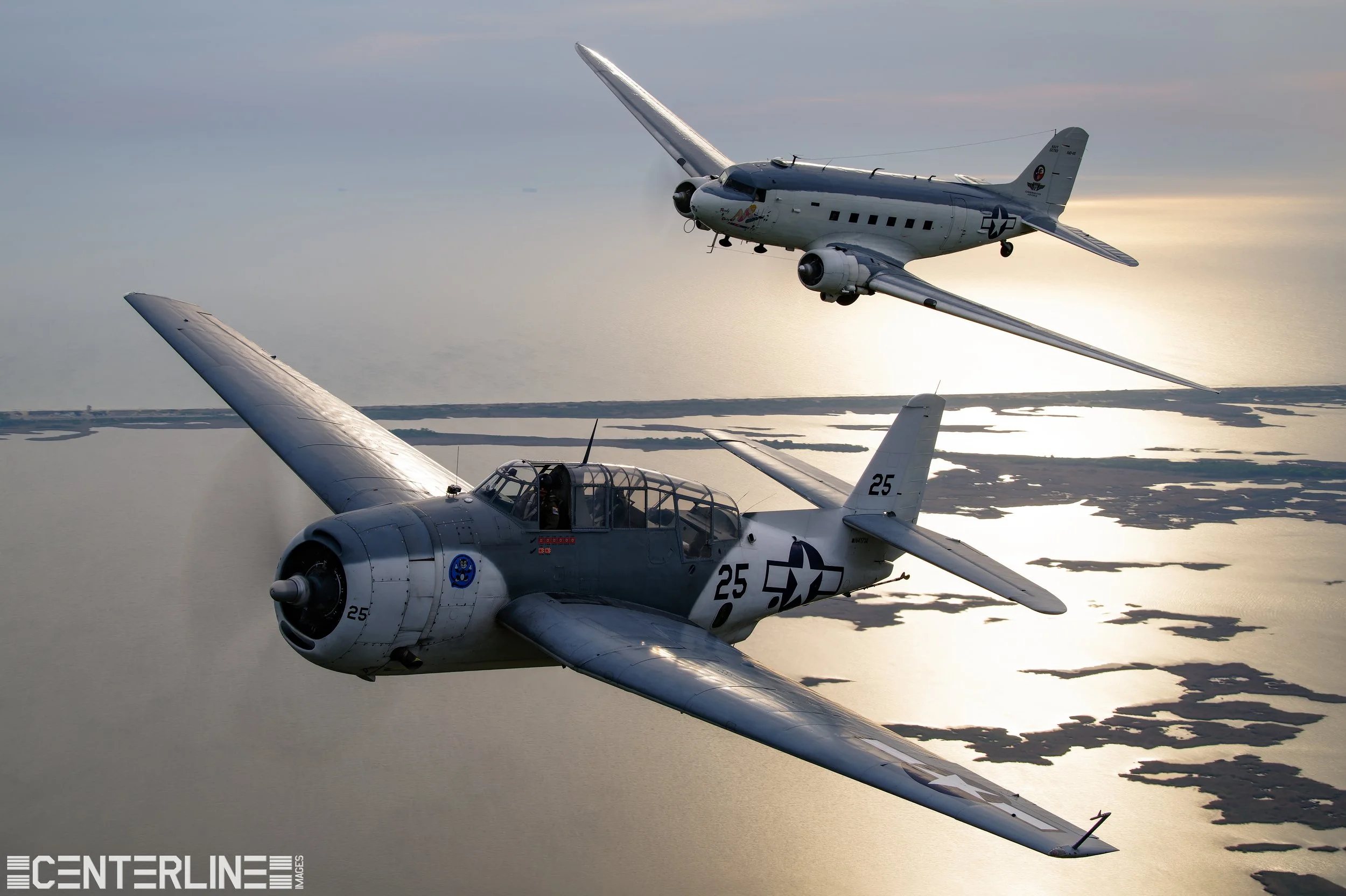 A Douglas R4D and TBM Avenger in flight over Virginia Beach sporting similar "Atlantic" paint schemes.