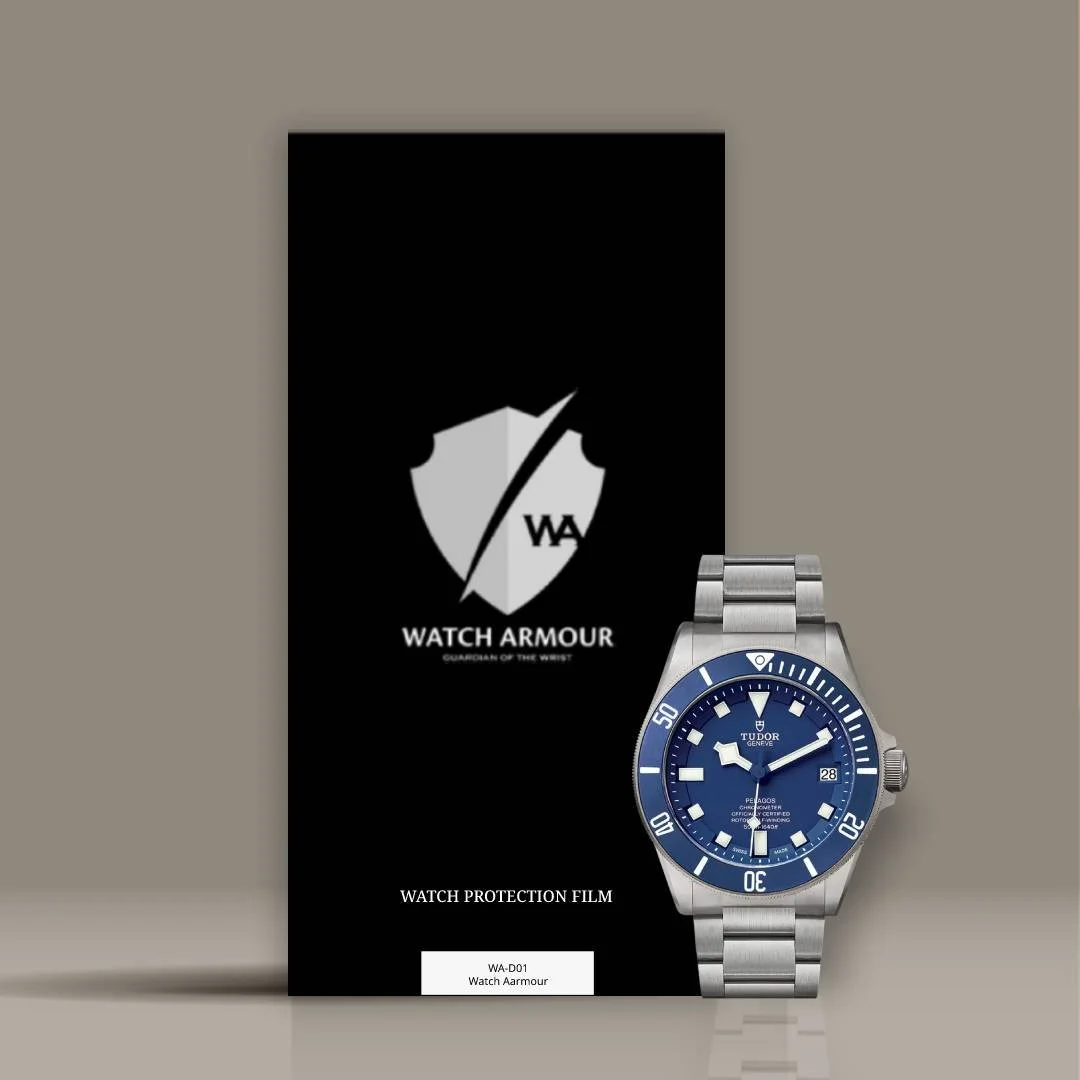 A blue Tudor Pelagos watch with a stainless steel band next to a black Watch Armour protection film package.