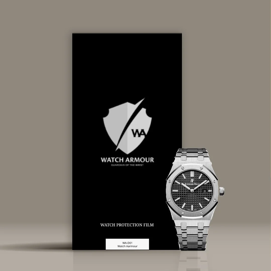 A black Watch Armour watch protection film package standing upright with an Audemars Piguet Royal Oak wristwatch with a black textured dial, stainless steel bracelet, and silver case placed to its right. The package features a shield logo with a diagonal line and the text 'WATCH ARMOUR' and 'GUARDIAN OF THE WRIST'.
