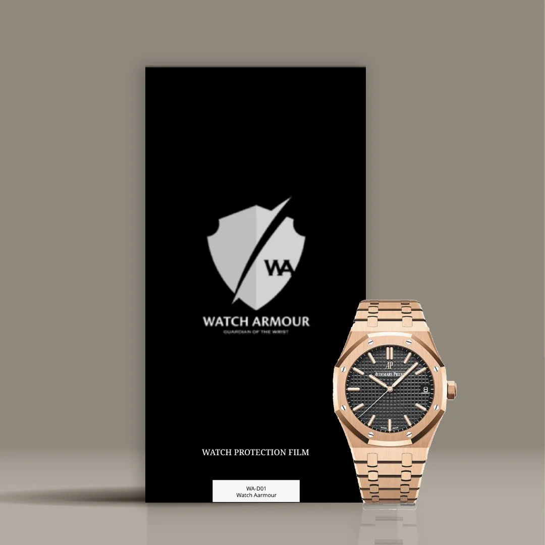 A black protective film packaging for a Watch Armour, with a gold Audemars Piguet Royal Oak wristwatch positioned in front of it. The watch has a black textured dial and a gold bracelet.