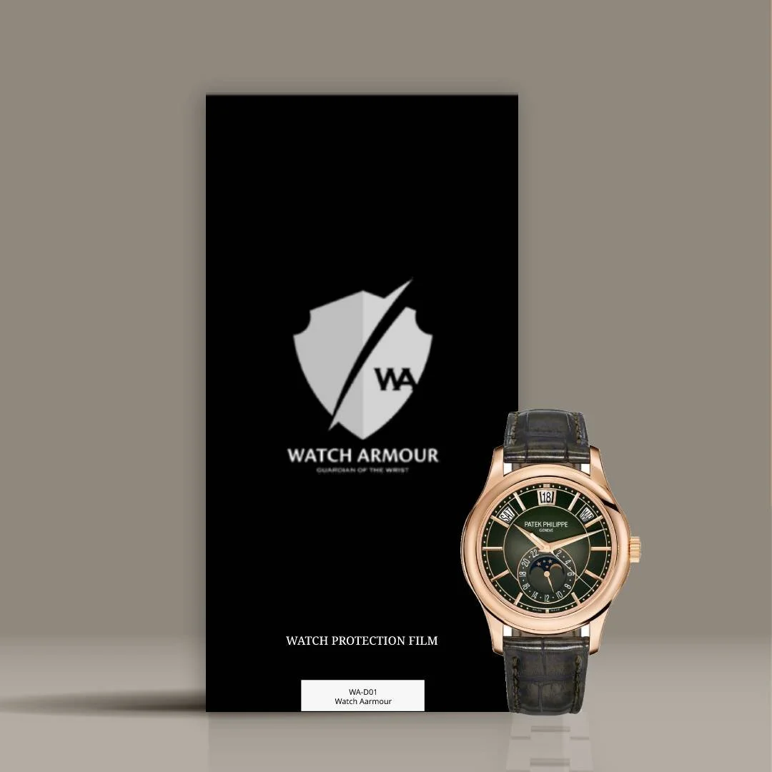 A luxury wristwatch with a black strap and a green dial, placed in front of a black packaging box with the Watch Armour logo and text.