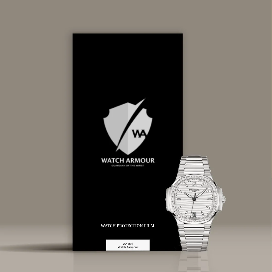 Black packaging for Watch Armour protection film with the Watch Armour logo, which features a shield divided by a lightning bolt and the initials WA, along with a silver wristwatch with a metal band, white face, and small date window, placed in front of the packaging.