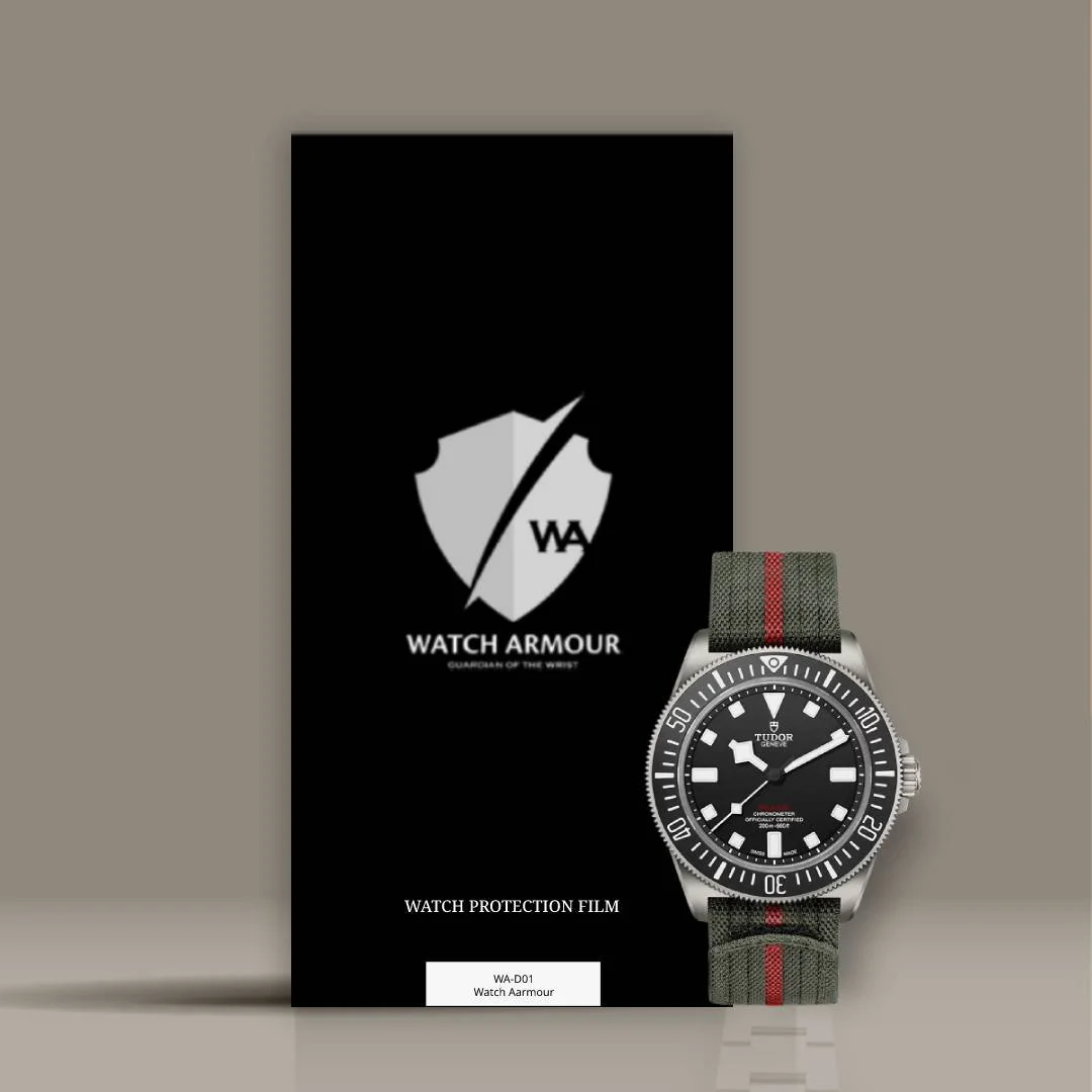 A Tudor dive watch with a black dial, luminous hands and markers, and a green strap with red stripe, positioned in front of a black Watch Armour protection film box.